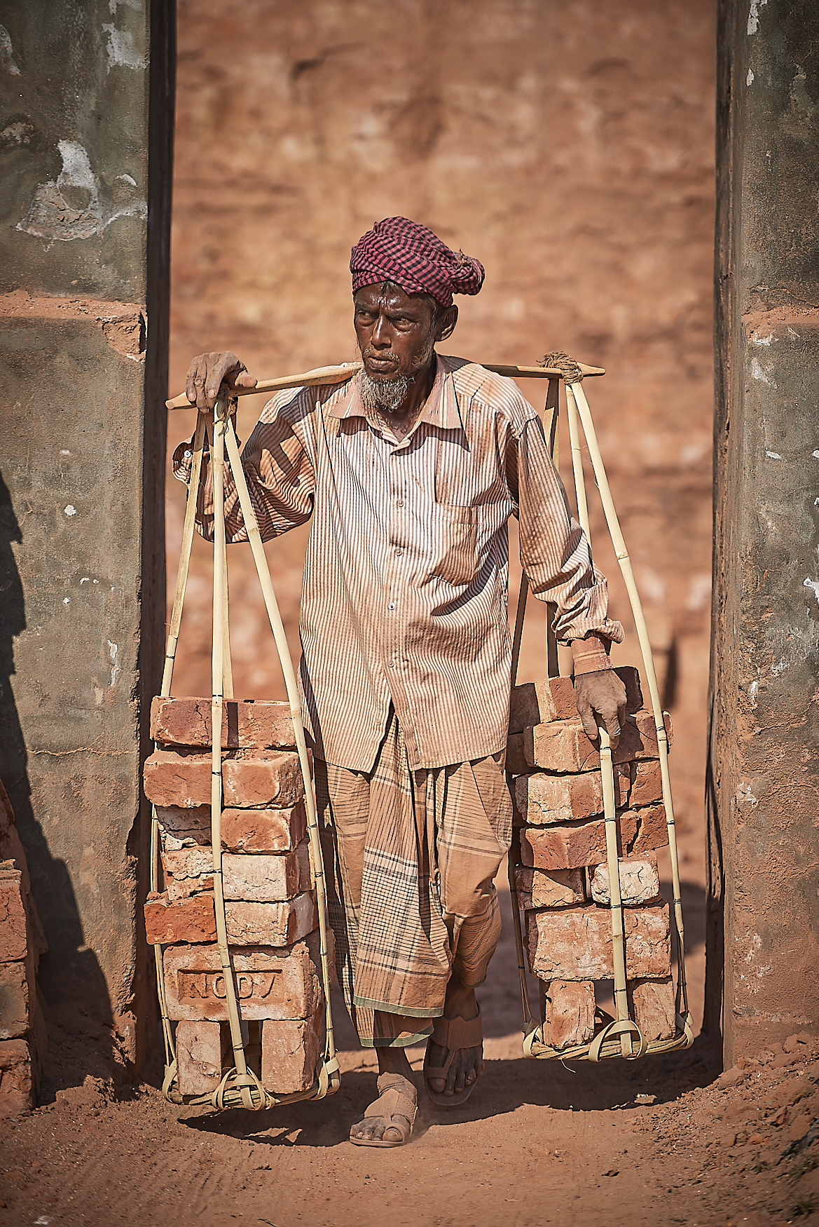 worker removing baked bricks from the kiln