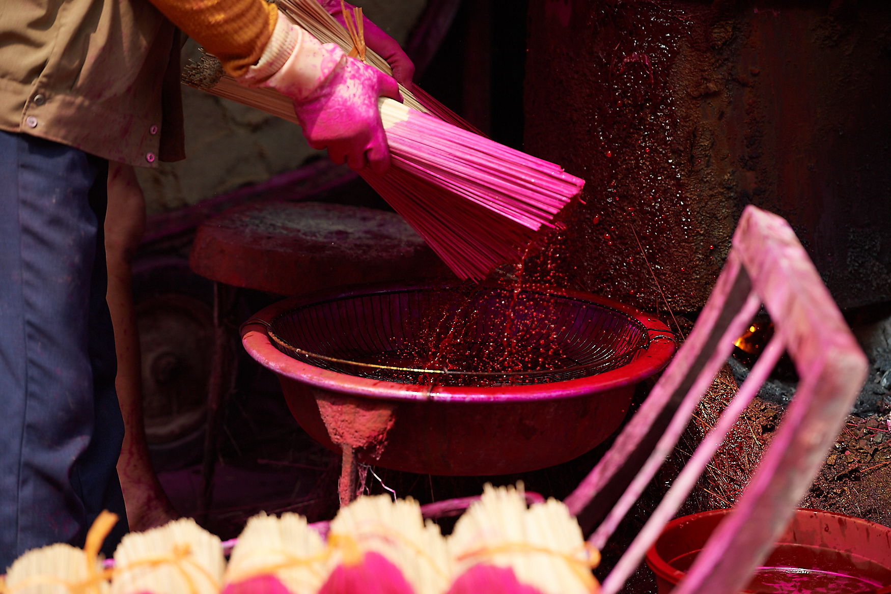 Sticks are being dyed repeatedly until the desired colour is achieved