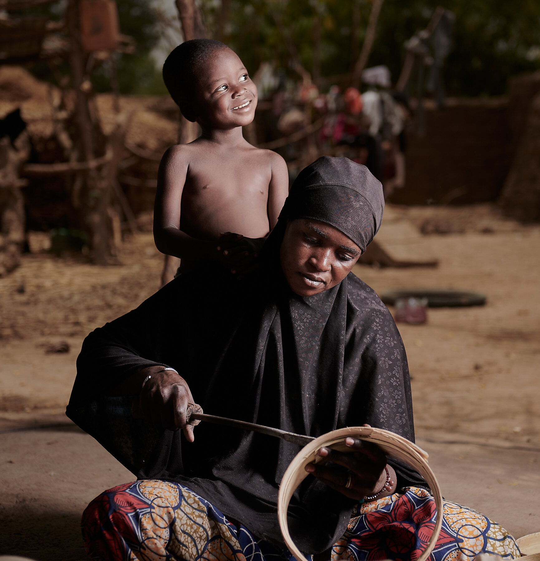 Calabash worker and her son, village near San