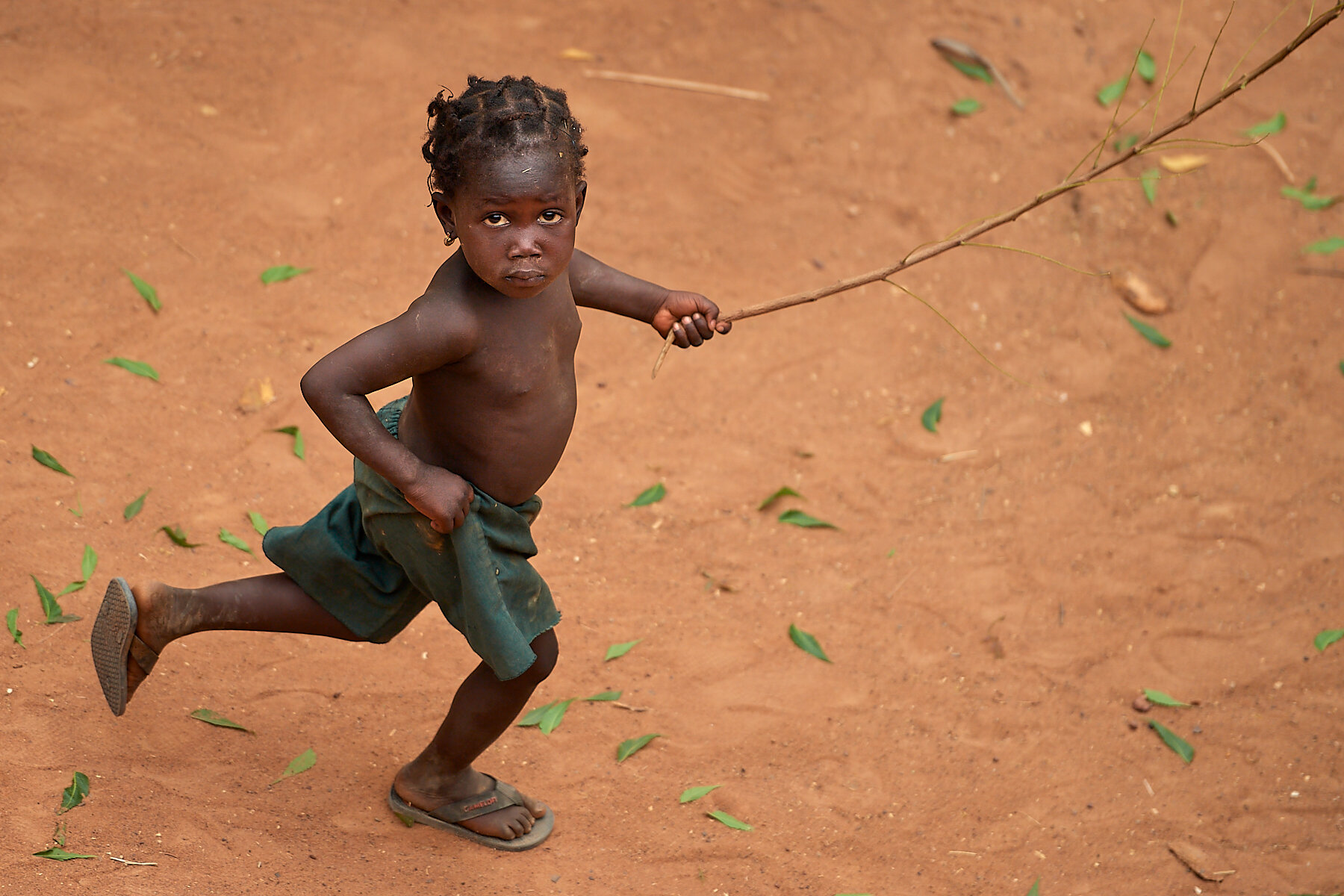Young child running and playing, village near Segou