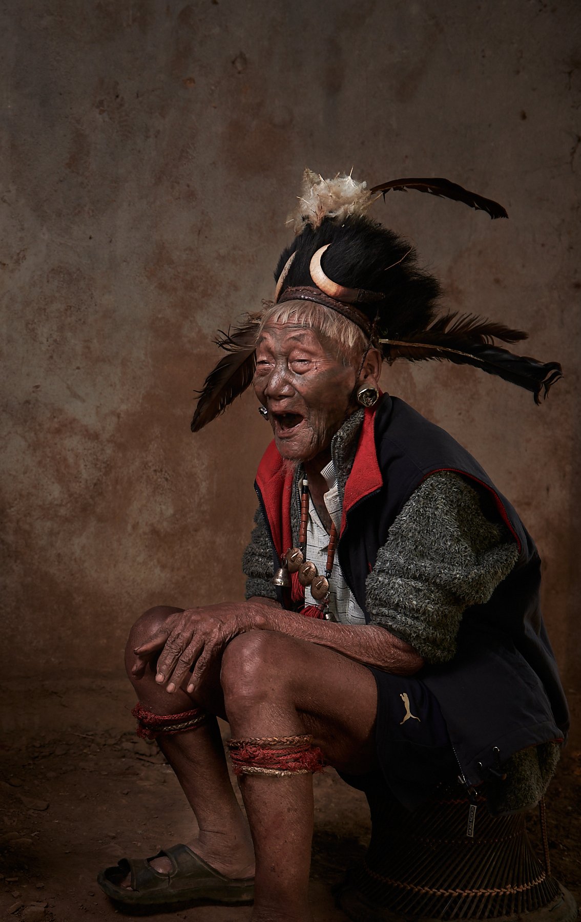 A Konyak hunter laughing at his friend's expense, Nagaland