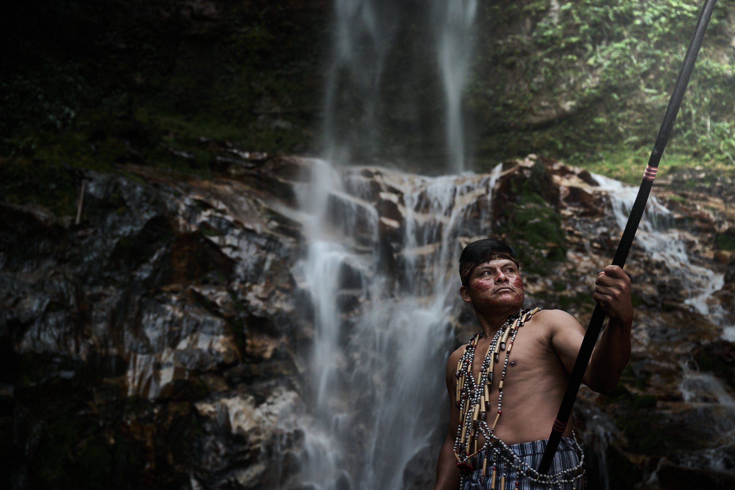 Shiram, a young Shuar warrior at the Yantsua waterfall