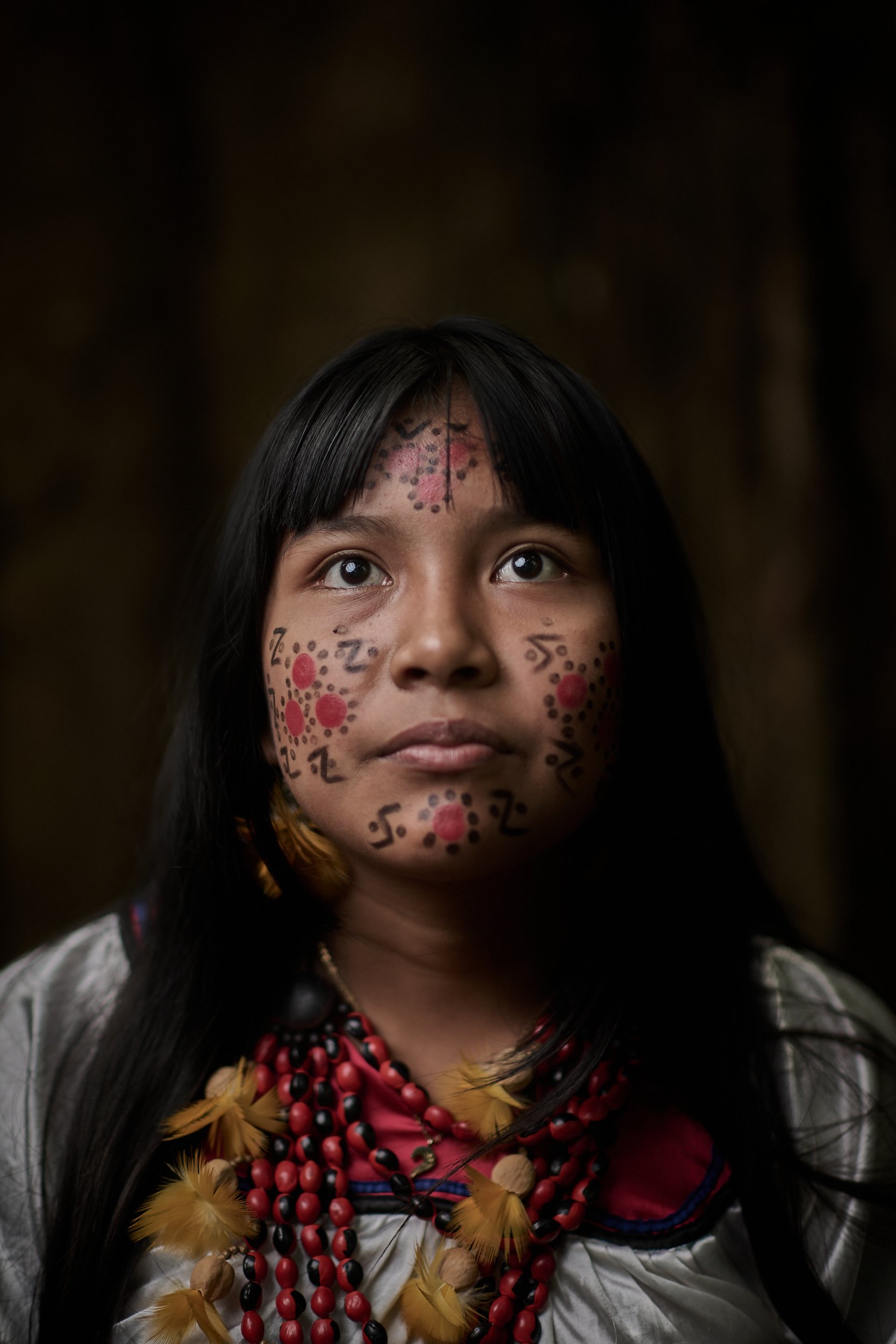 Jhuliana, a young Cofan girl with traditional clothing and face painting