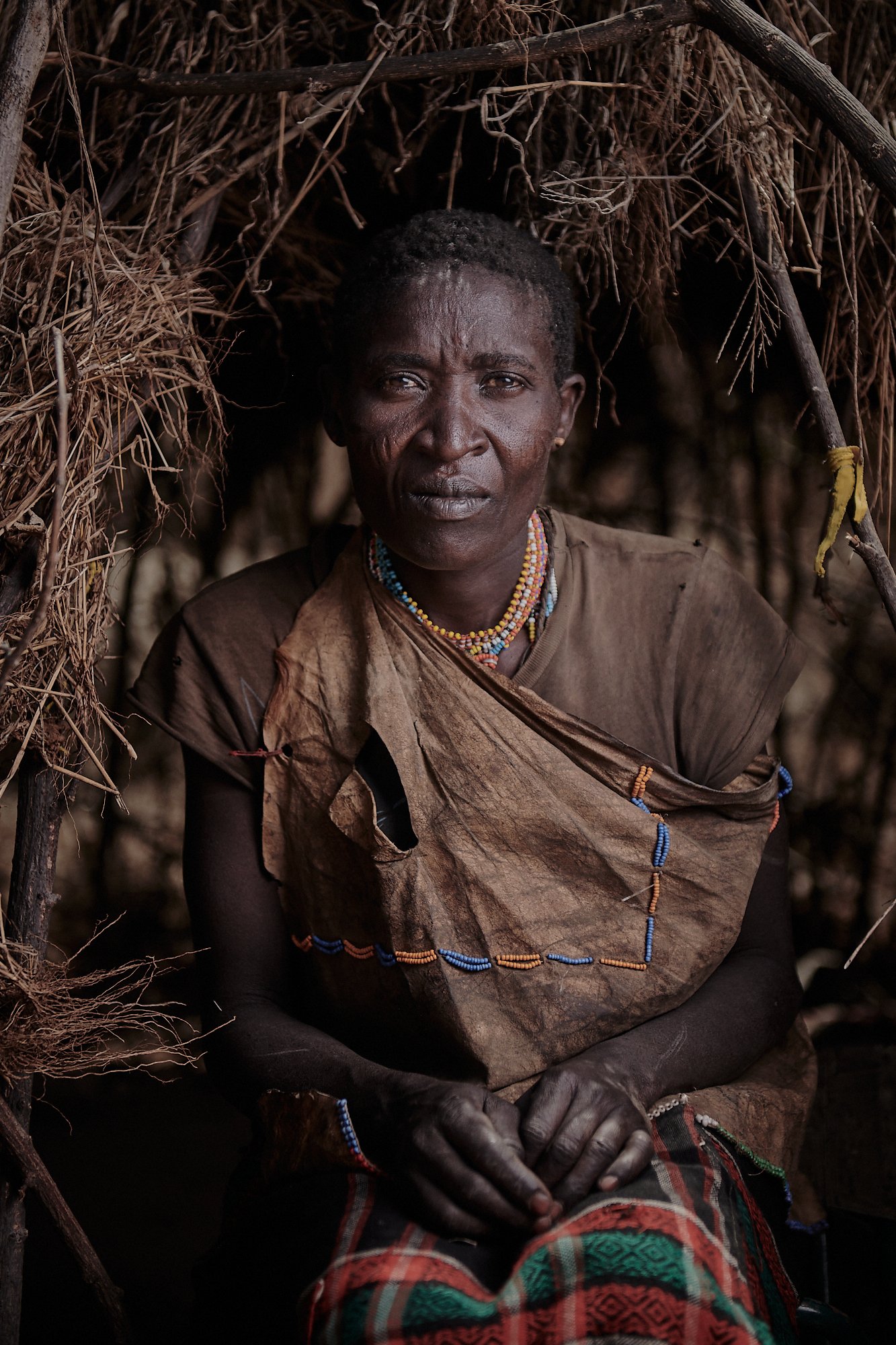 Young Hadzabe woman in the village meat storage hut