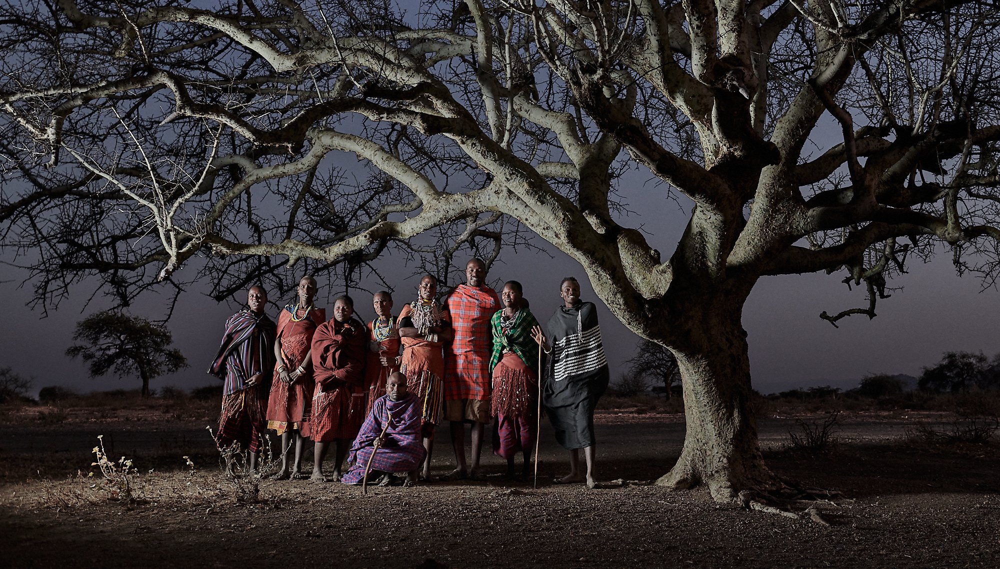 Members of the Datoga tribe just before dawn under the sacred village tree