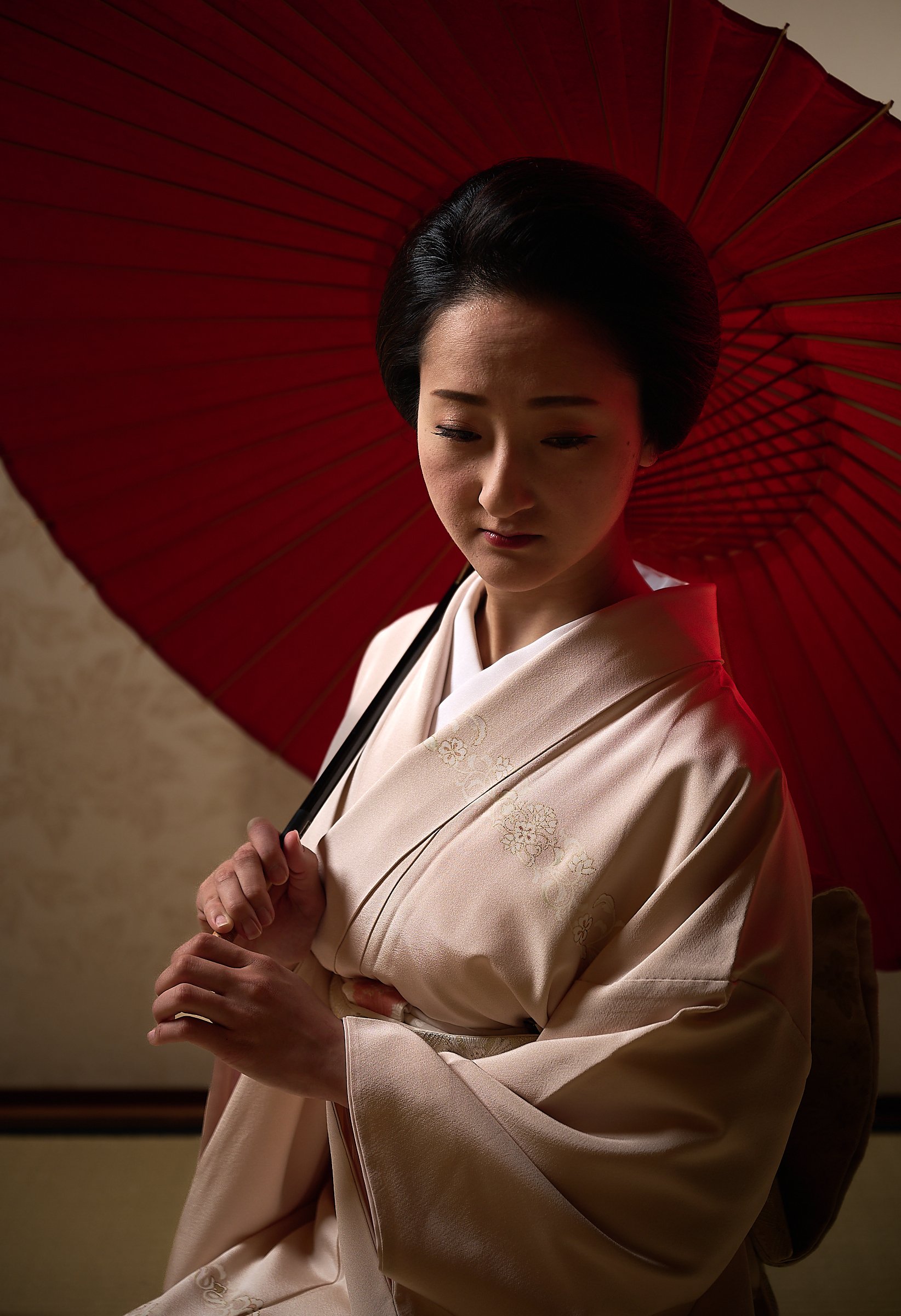 When a geisha goes outside in the sun on foot, they almost always carry an umbrella