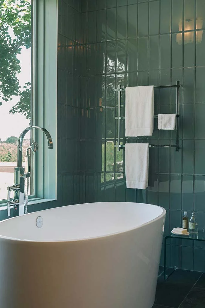 Freestanding soaker tub in master bathroom retreat. Interior design by Four Blocks South, Toronto, Canada.