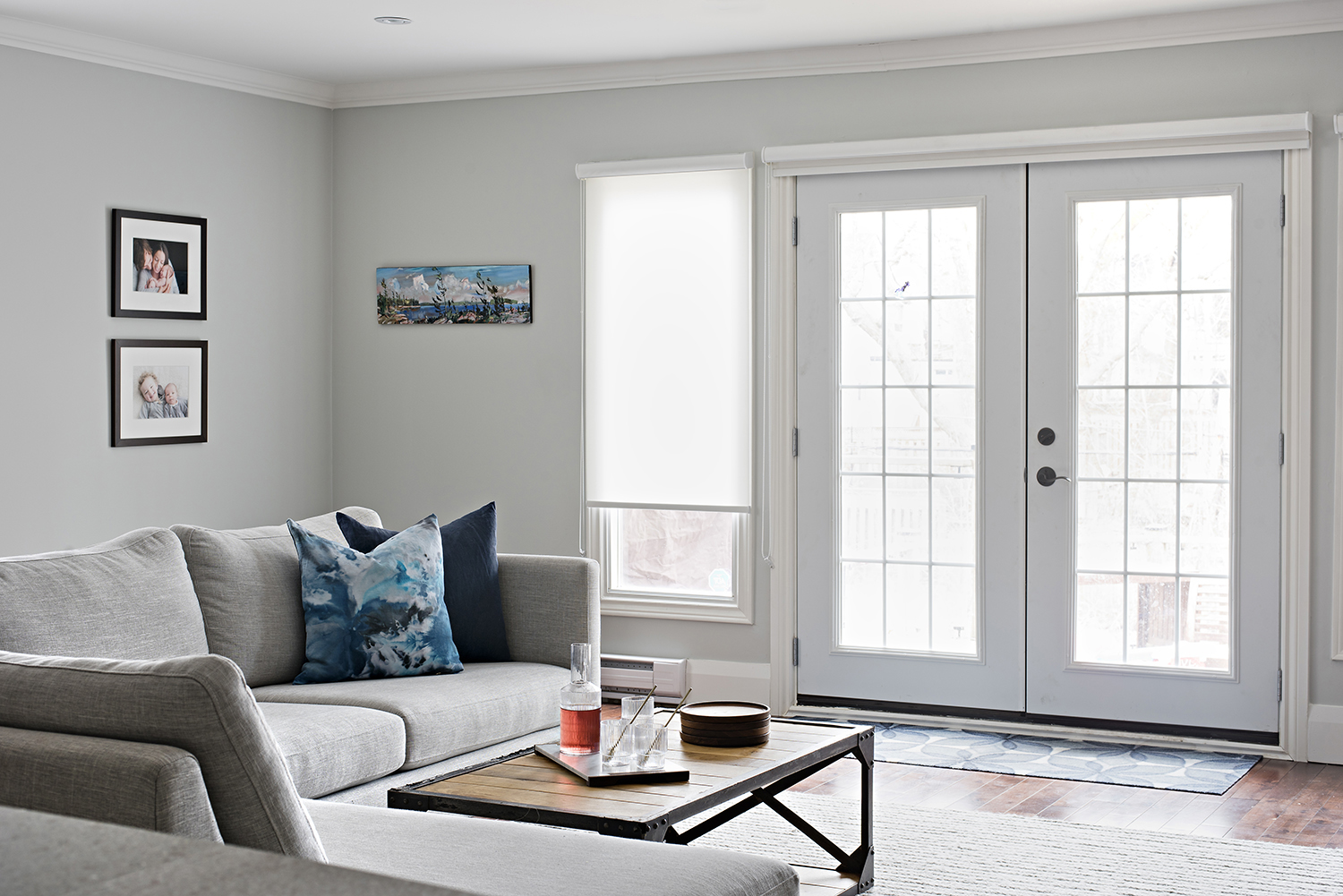 Bright living room area with large couch and french doors
