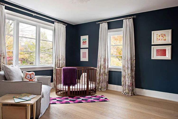 This nursery is calm and warm while using a very saturated deep teal wall paint.