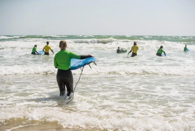 Heading out to sea with the group to try surfing for the first time