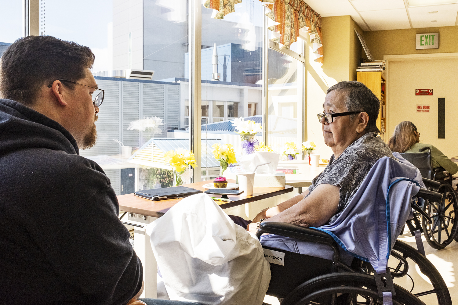 David Robert Boxley meeting with his Tsimshian language teacher, G̱oodm Nluułgm Xsgiik - Sarah Booth, in a hospital in Ketchikan, Alaska.