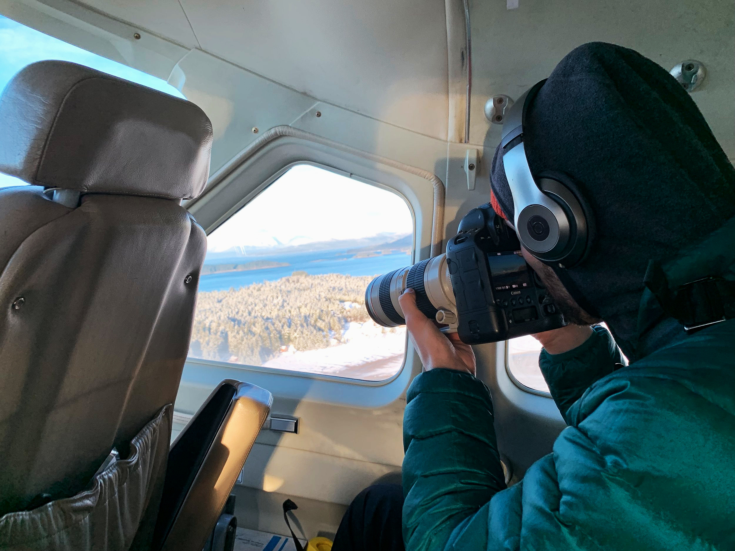 Soulcraft Allstar Photographer Brandon Sawaya in a Seaplane taking photos above Southeast Alaska.