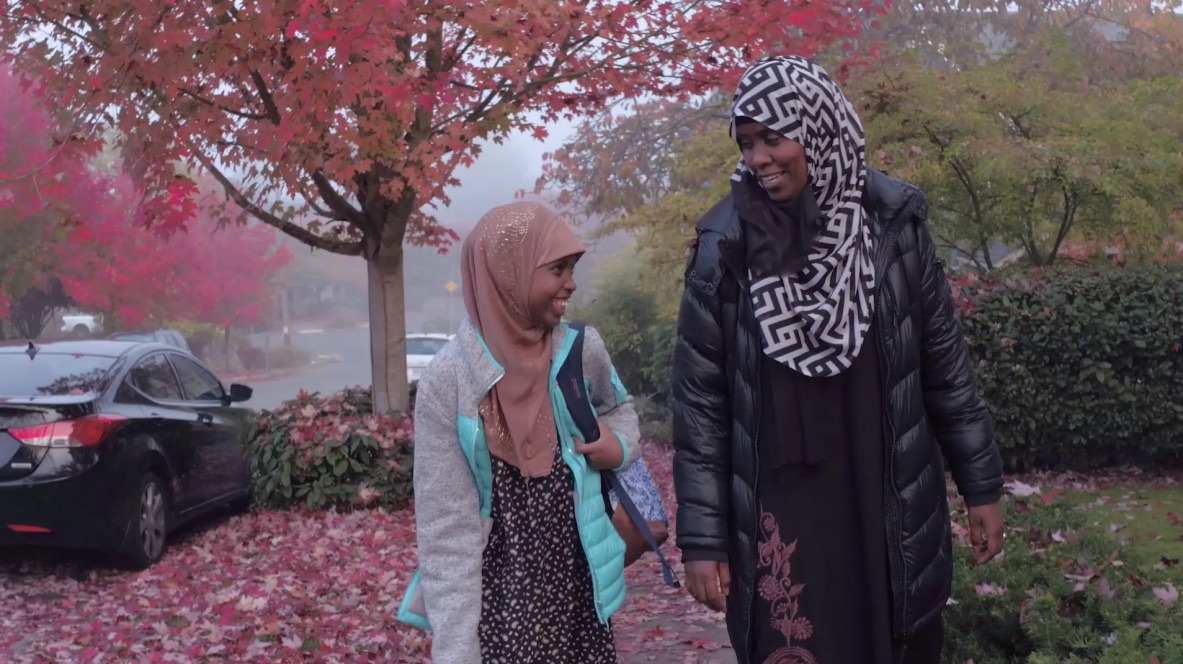 Halima and her mother Sara walking to the Seattle Public Library in their neighborhood.
