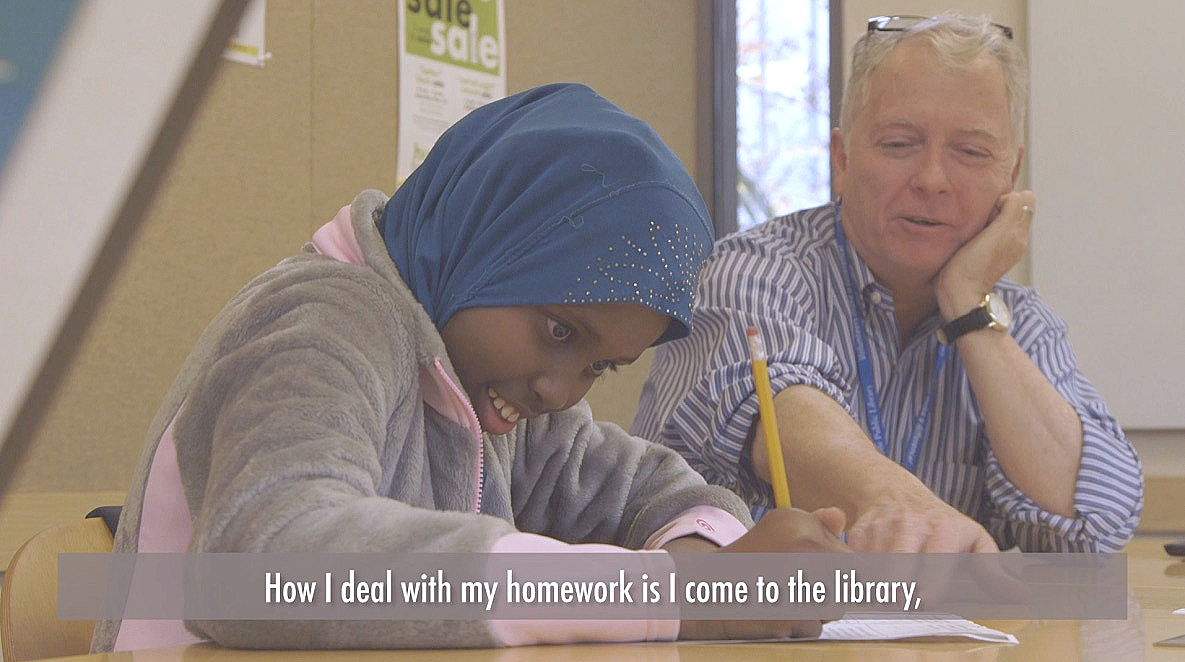 Halima gets help with her homework every day after school by one of the hundreds of volunteers who serve our community.