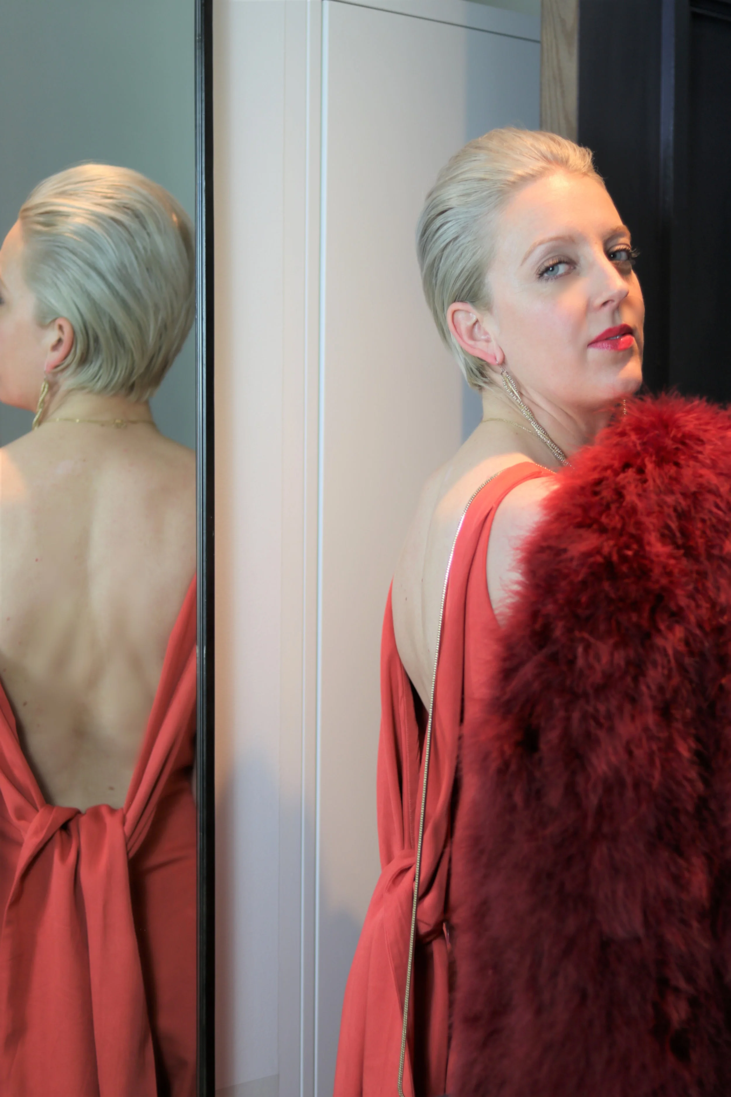 Jumpsuit: Nuorikko Nada Jumpsuit, Feather Coat: Rebecca Minkoff, Shoes: Halston, Bag: & Other Stories.