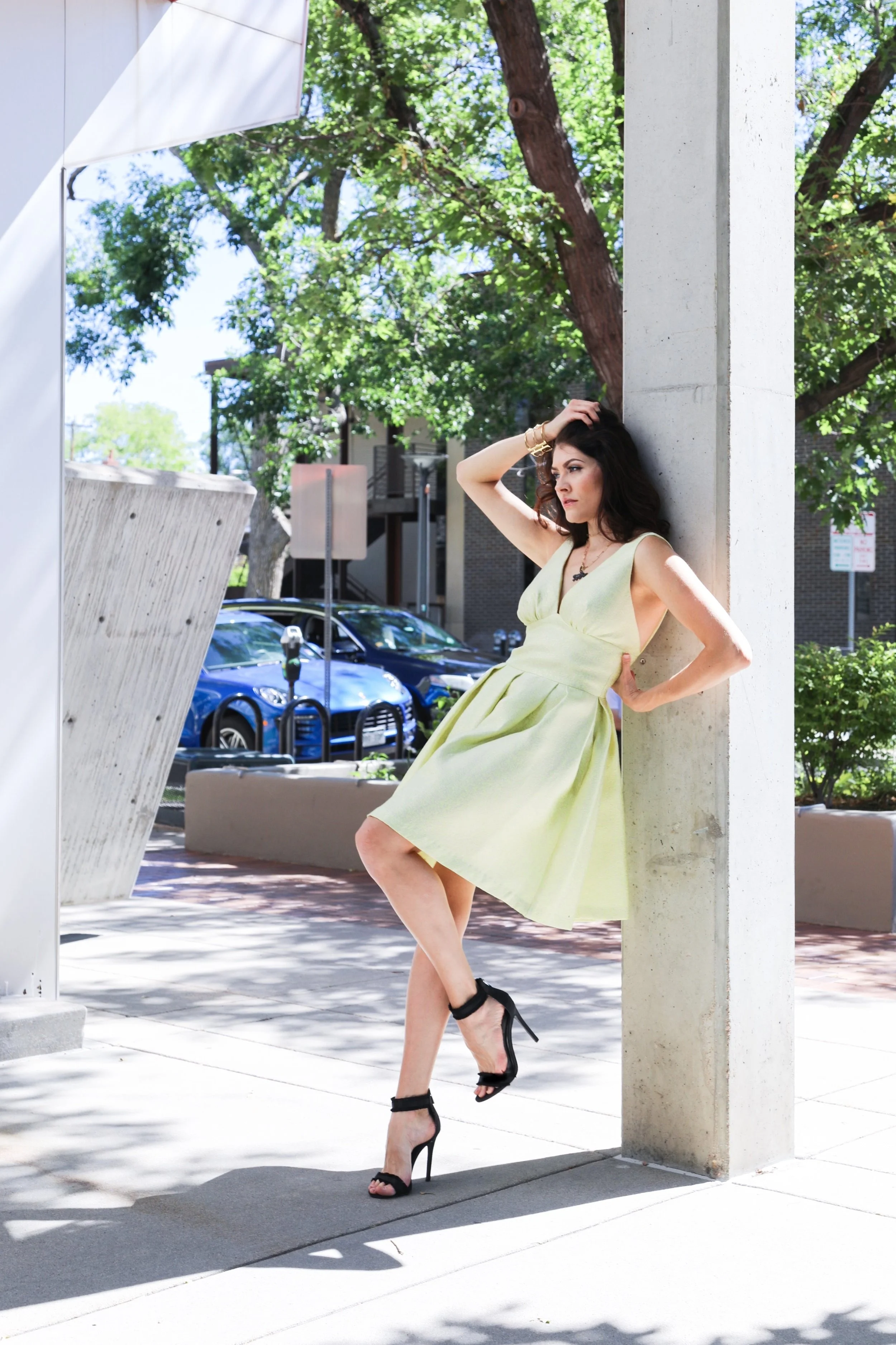 Model Hailey Spung on the corner of Milwaukee & 3rd Ave wearing yellow dress and jewelry from Mariel Boutique.