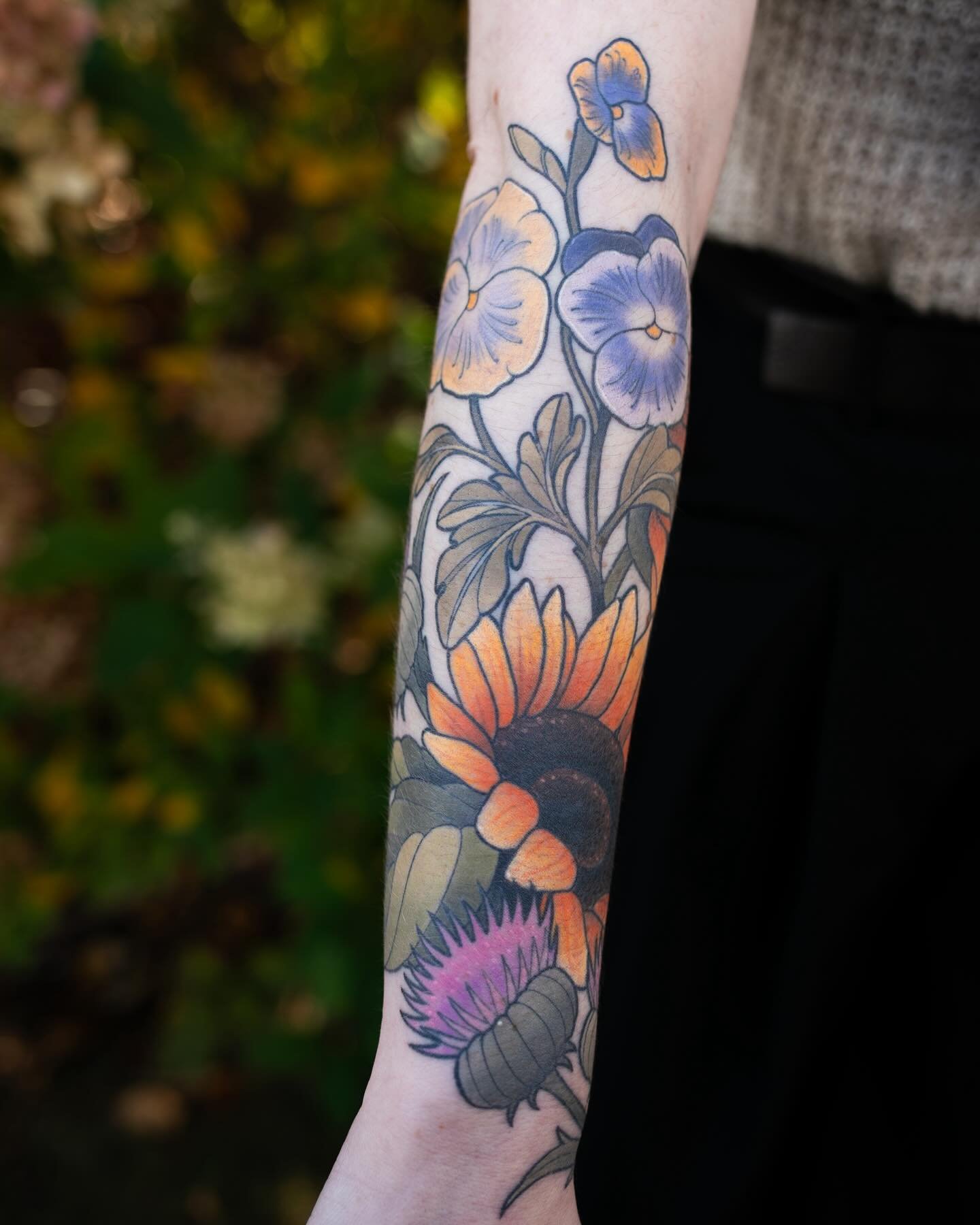 HEALED in the wild photos from @danielalisi on my client Nicole 🌻 thank you friends! 
✸
#neotraditional #healedtattoo #sunflower #pansies #thistle #michigantattooartist #michiganphotographer
