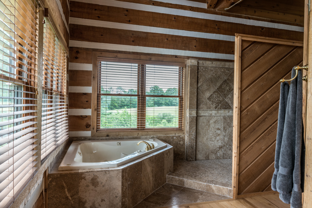  The master bathroom includes both a corner Jacuzzi with windows overlooking our fields on both sides and a spacious full tiled double shower. 