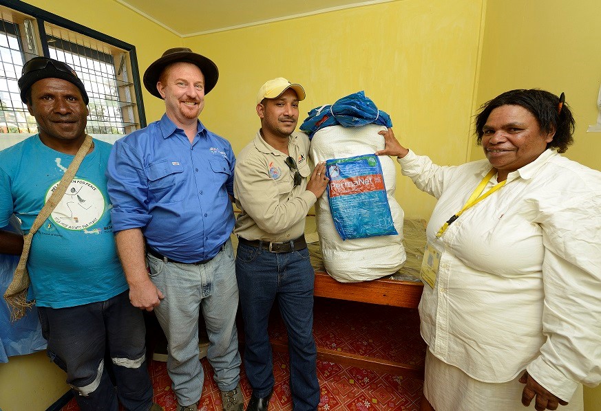 The most effective means of preventing malaria is sleeping under a mosquito net , specifically a long-lasting insecticide treated net or LLIN. Seen here, Oil Search Foundation’s Hela Provincial Development Manager Rodney Ingersoll (in blue shirt) with partners receive bed nets for distribution in the province