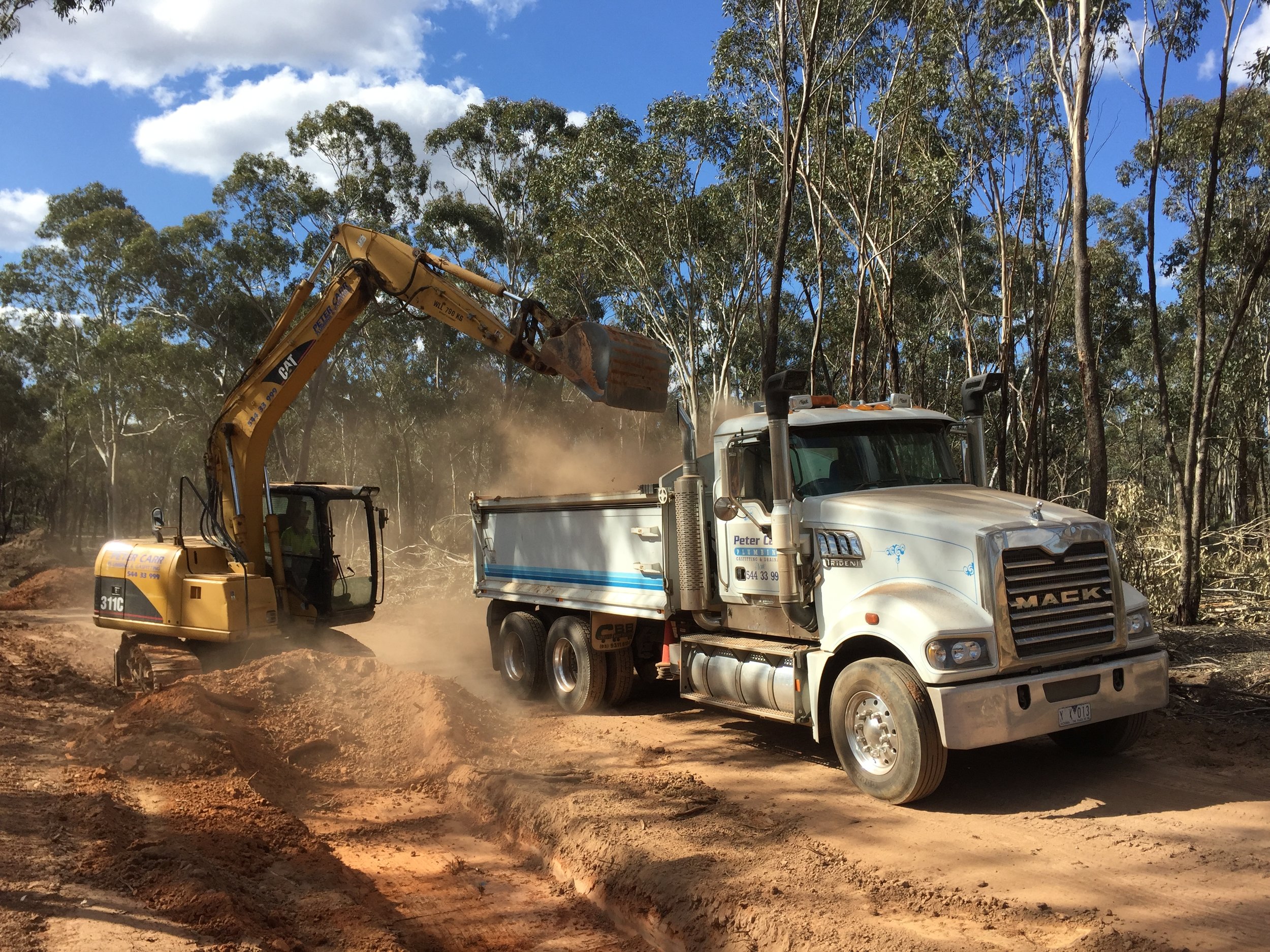 Excavator loading truck