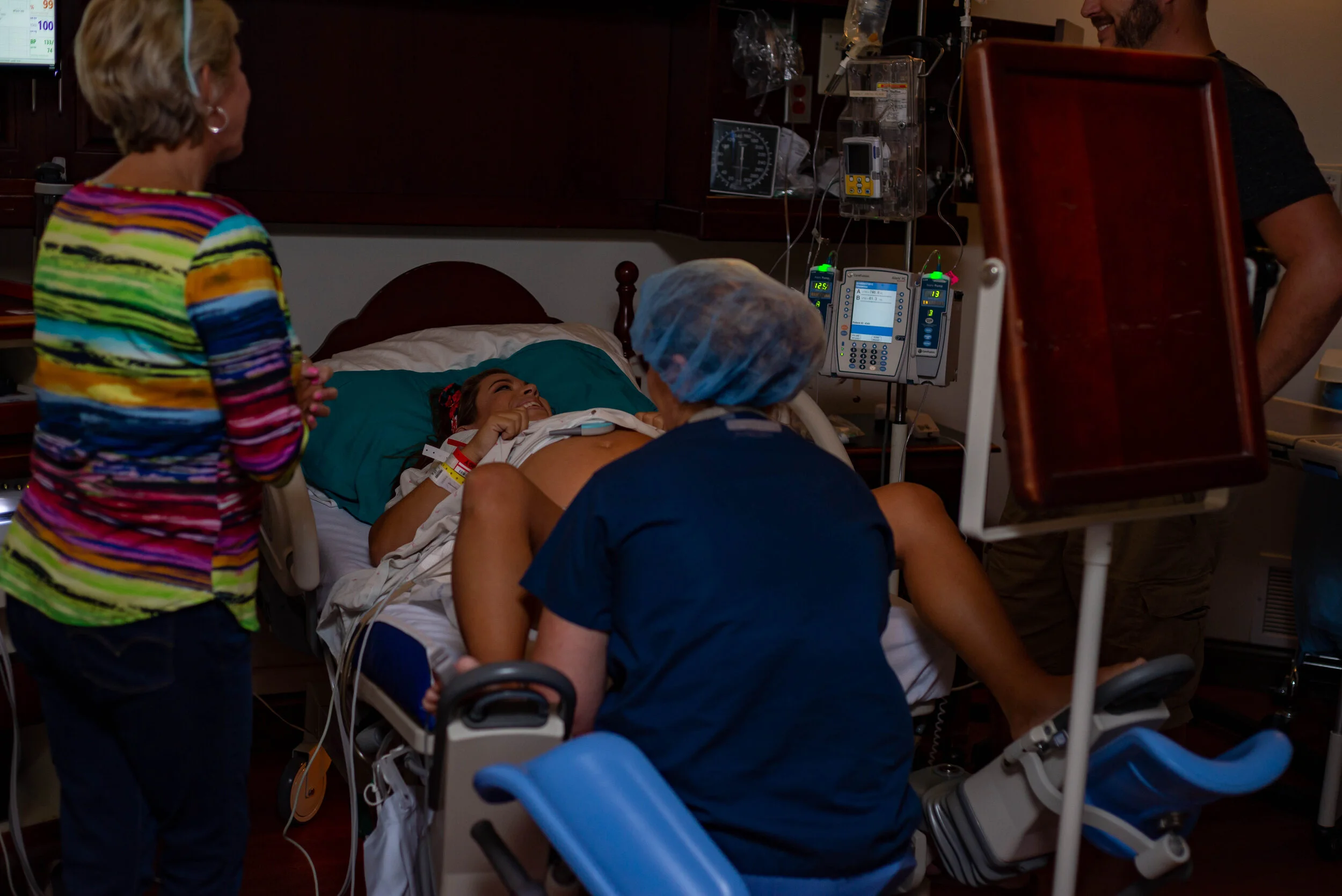 mom and dad smiling at each other while they joke around inbetween contractions