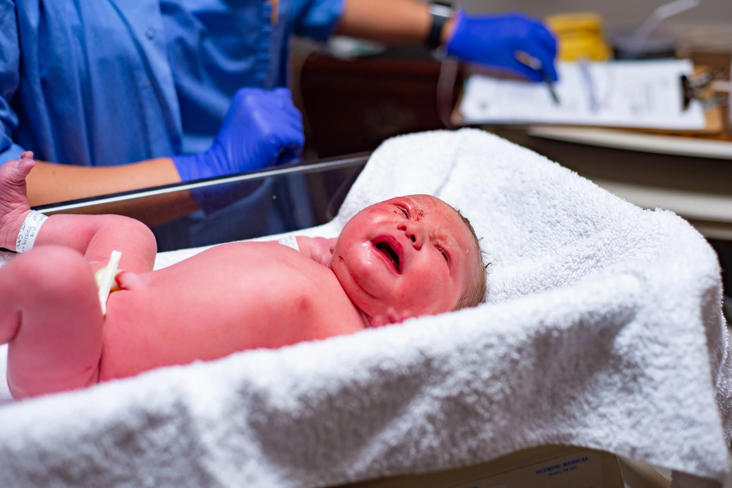 newborn being weighed