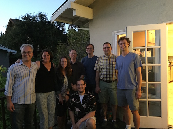 Photo of a team gathering outside of a house.