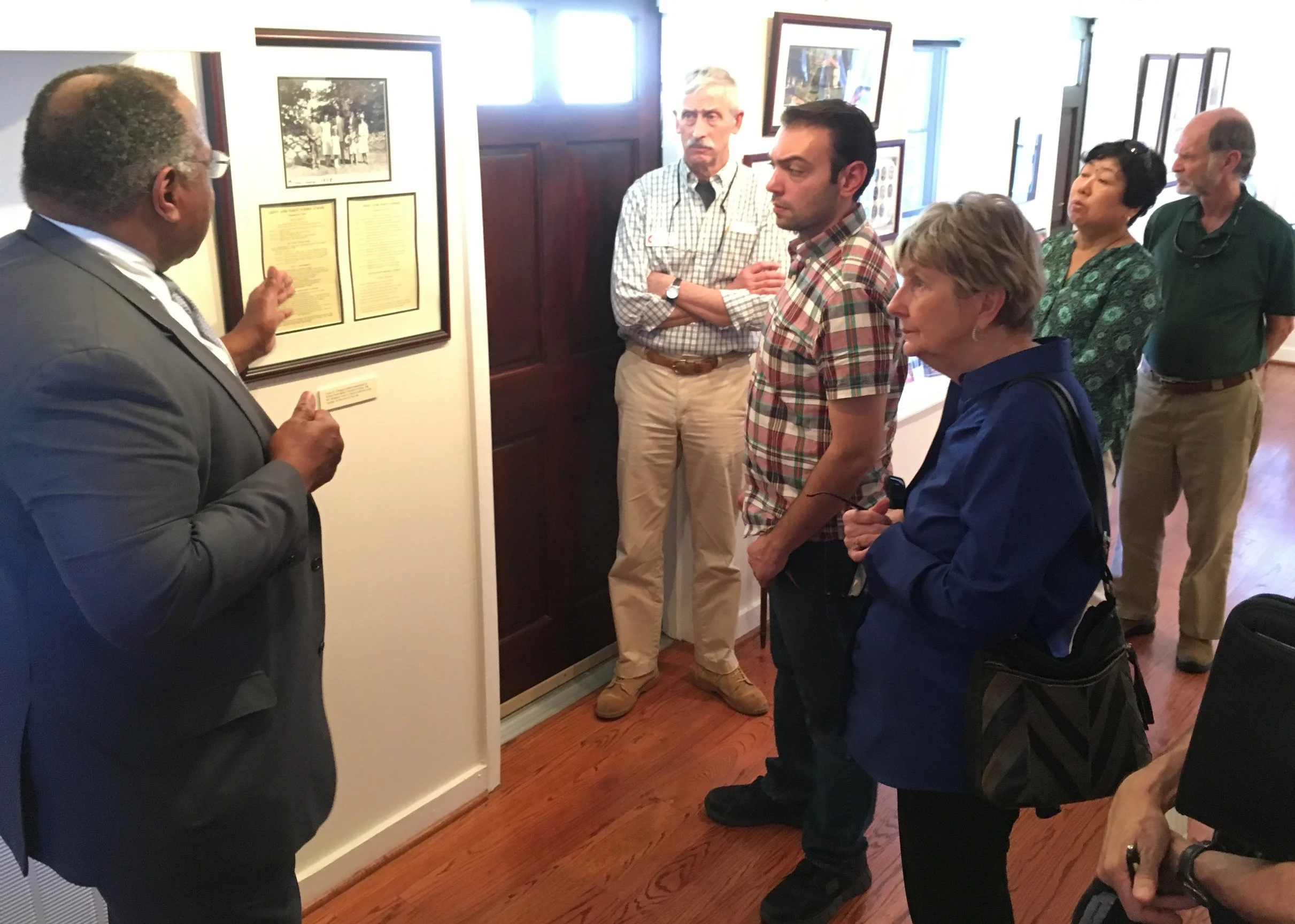 Participants learning about the history of the Baha’i community in Charleston while touring the Louis G. Gregory Baha’i Museum.