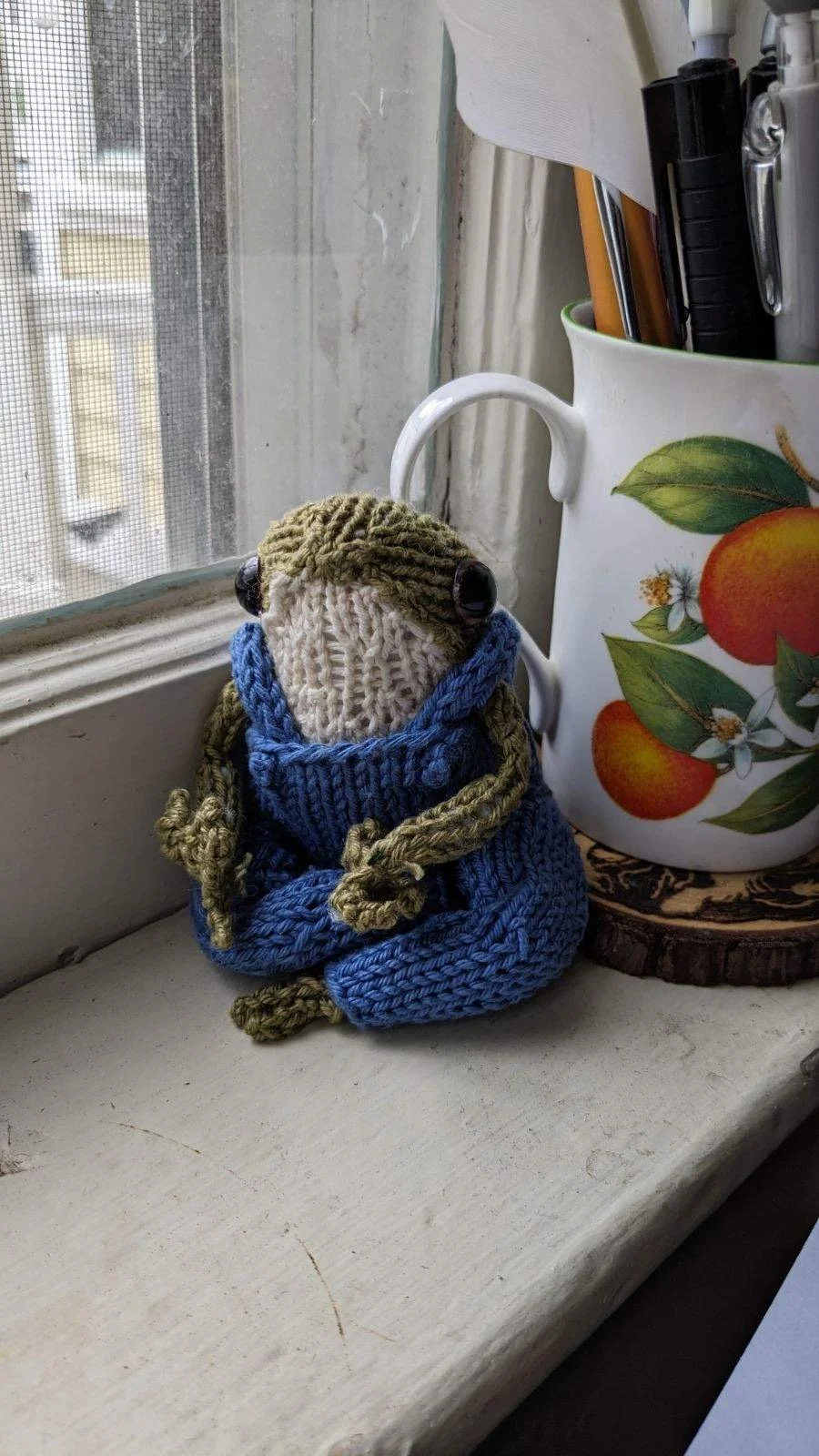   Ellie Stalcup    Untitled , 2023  Knitting   Description:  My art is a knitted miniature frog. He's wearing a pair of knitted overalls. 