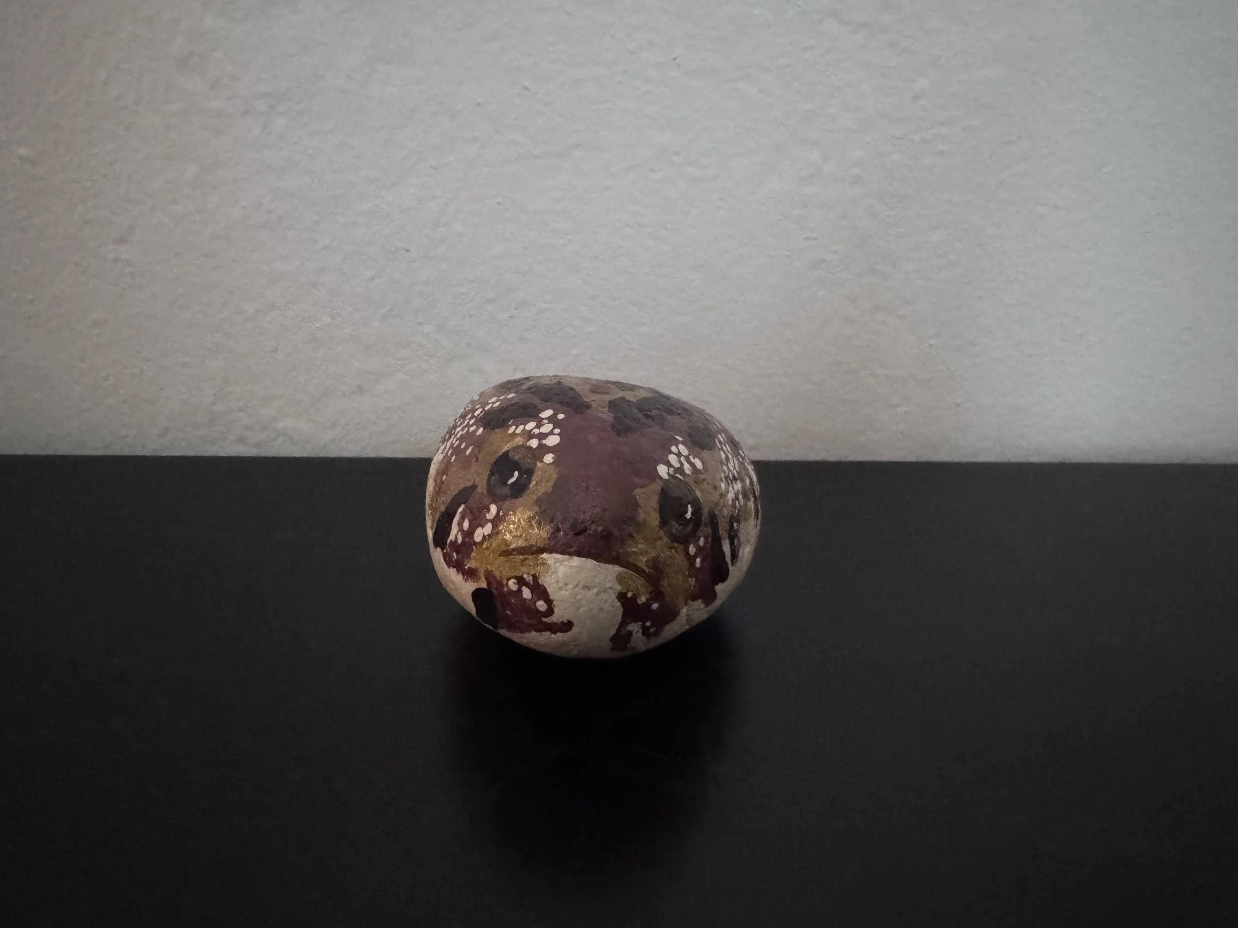   Alexandra Corrin    Frog Rock , 2022  Found rock and acrylic paint   Description:  Its a rock that I painted to look like a chubby rain frog for my boyfriends birthday 