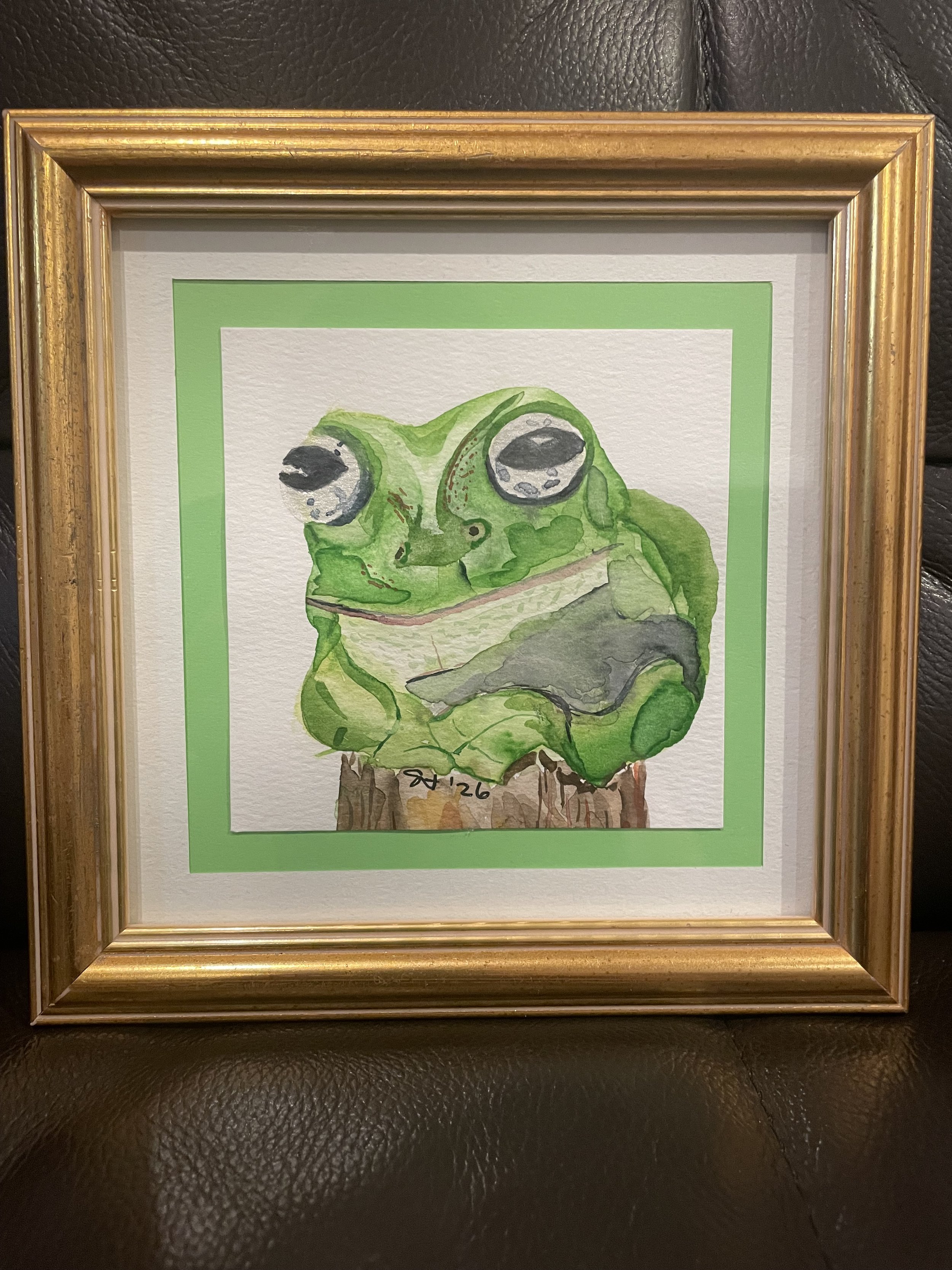   Sara Wright    Rhymes with frog: agog, / interior monologue, / downward facing dog , 2026  Watercolor on paper   Description:  This is a portrait of a White’s tree frog (Litorea caerulea) from Ithaca, NY’s Sciencenter.   Artist background:  I am a 