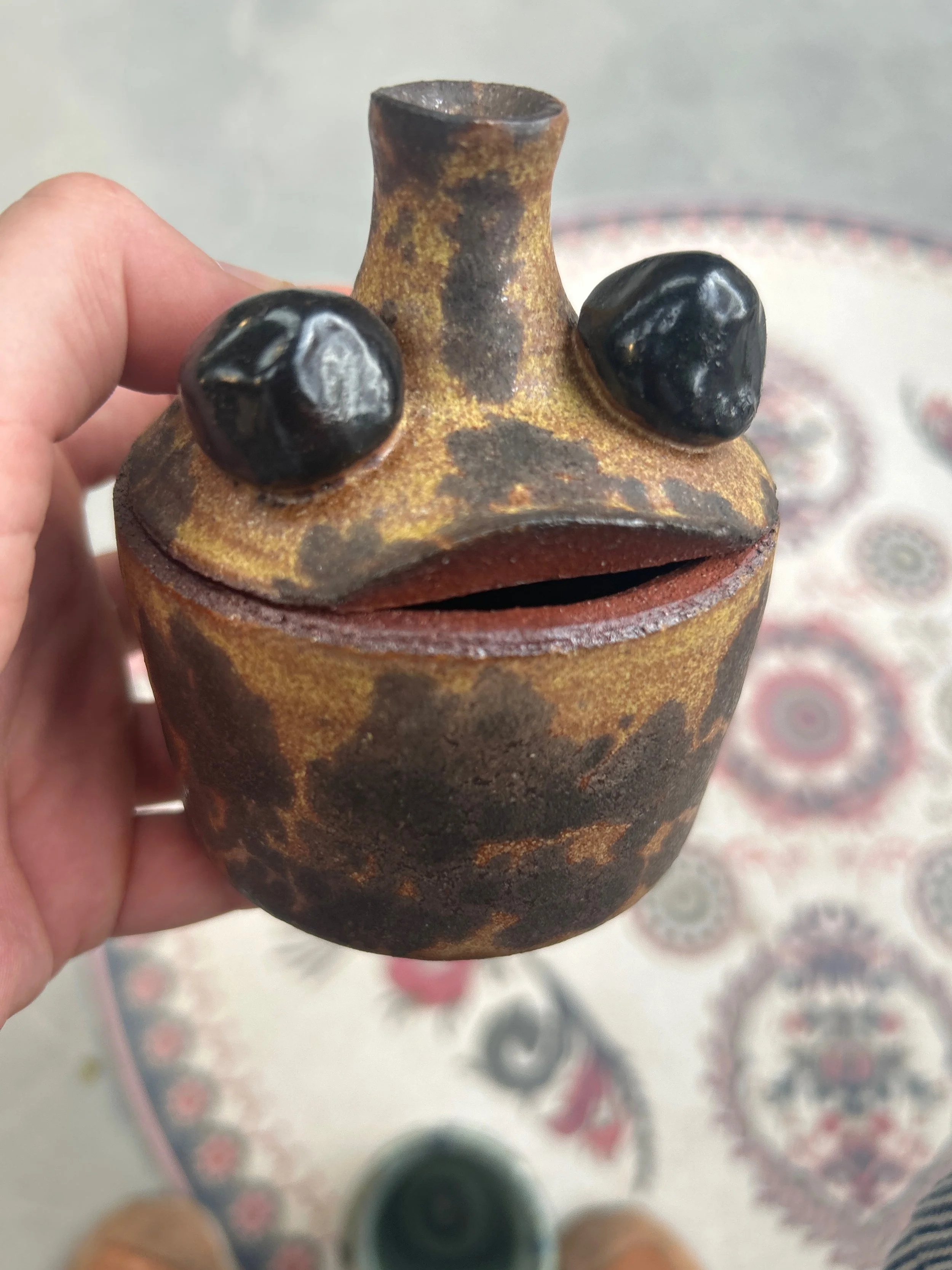   Maya Smolarek    Untitled , 2026  Clay, wheel thrown   Description:  This is a little jar inspired by frogs! 