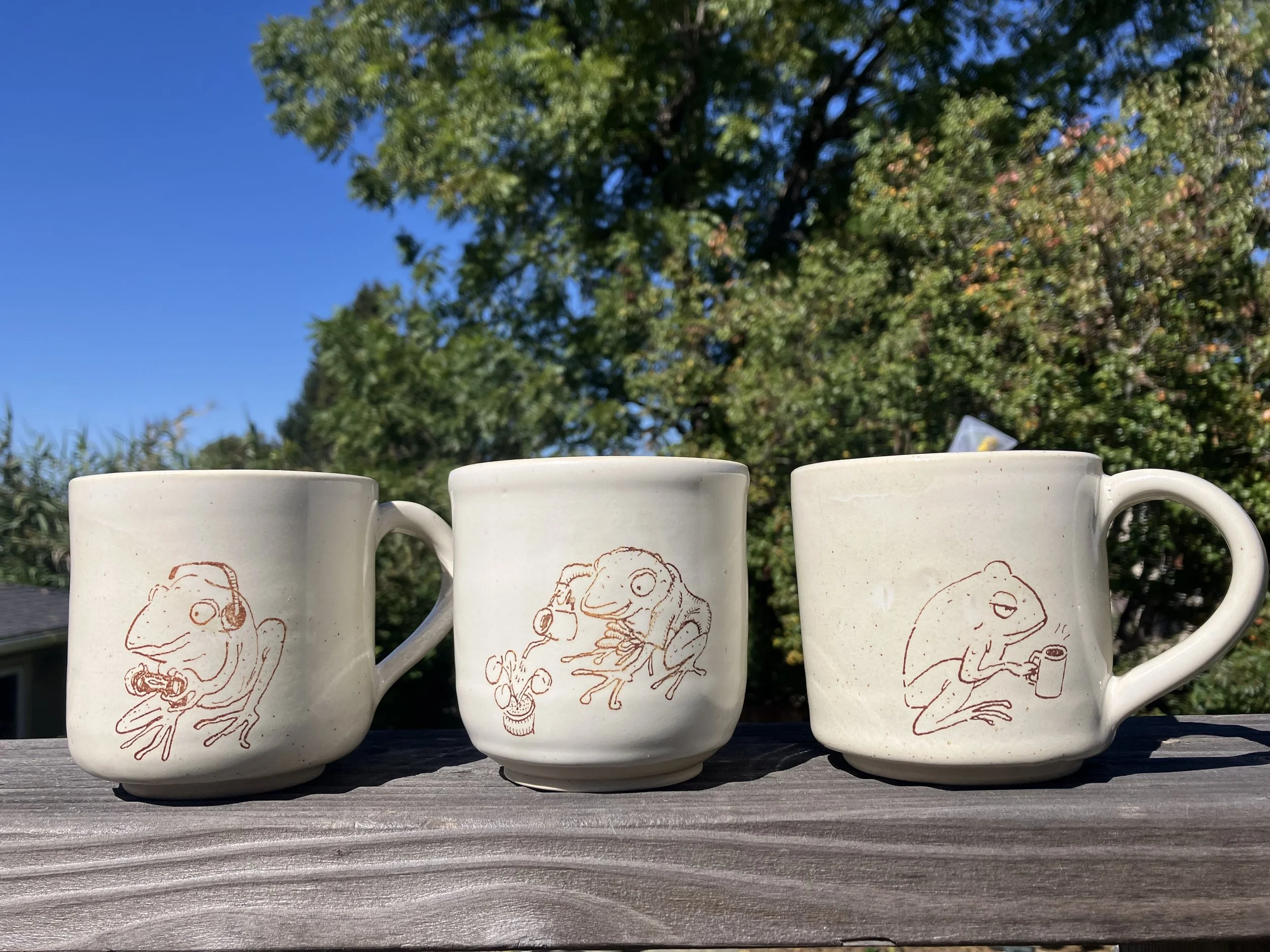   Brittney Nguyen and Ariel Dungca    Recreational frogs , 2024  Pen (Ariel Dungca) transferred onto ceramic (Brittney Nguyen)   Description:  These frog drawings are based on a real type of frog (adult female Coqui). 