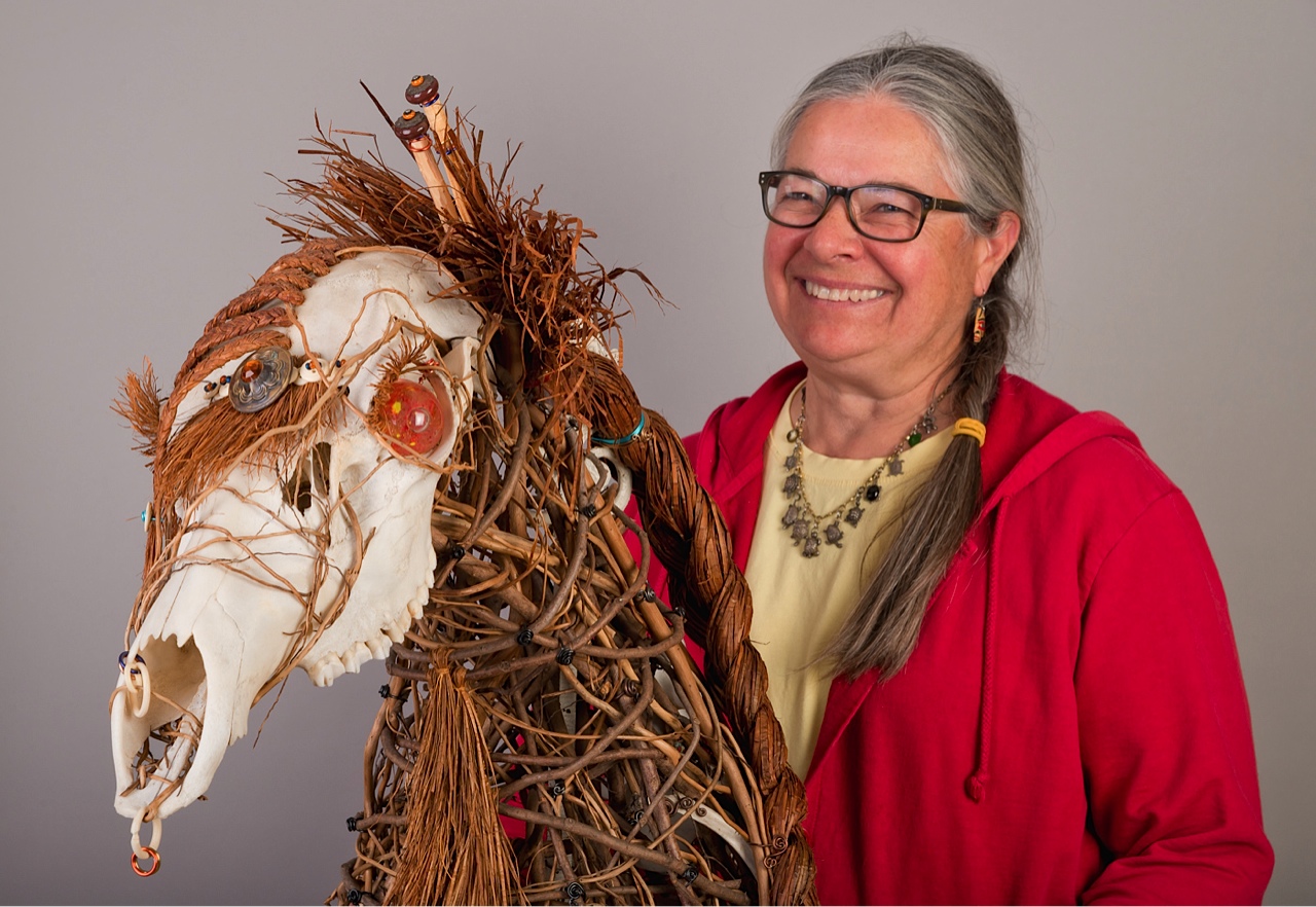 Sue Skelly with Queen of the Forest made of Cedar and Elk bones.