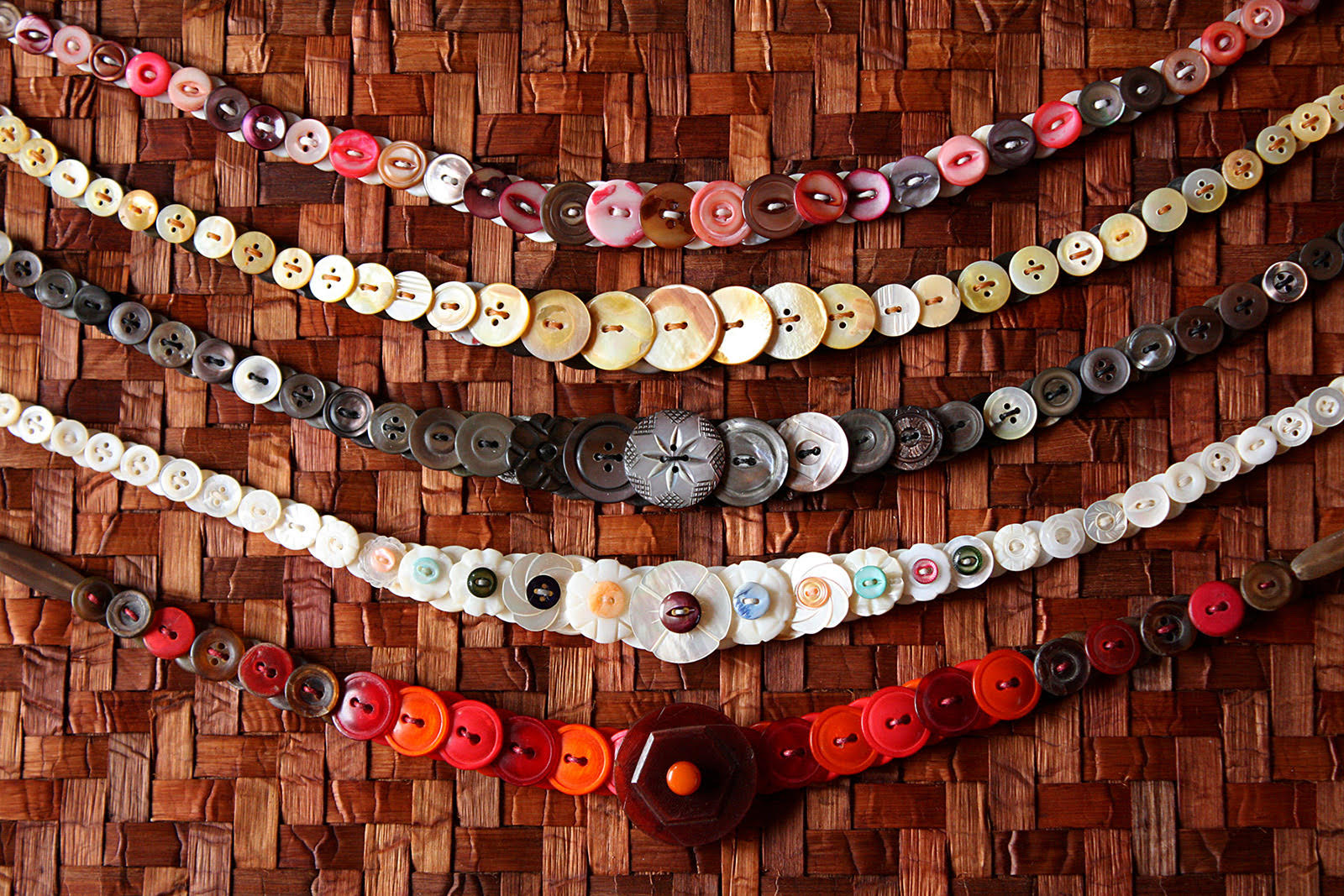 5 Antique Button Necklaces on a Woven Cedar Bark Table Runner