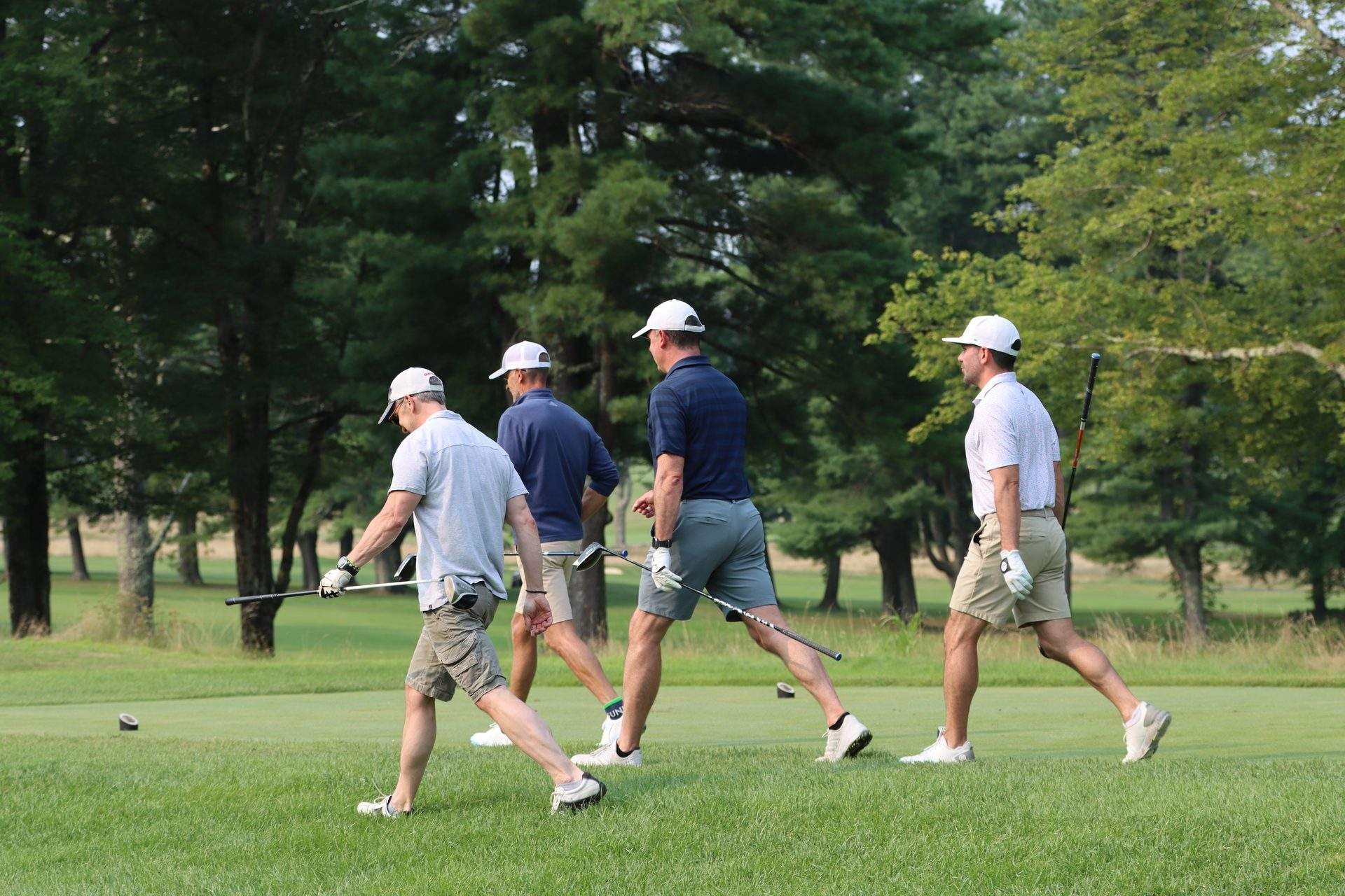 dannys-place-golf-tournament-foursome-walking-wooded-fairway.jpg