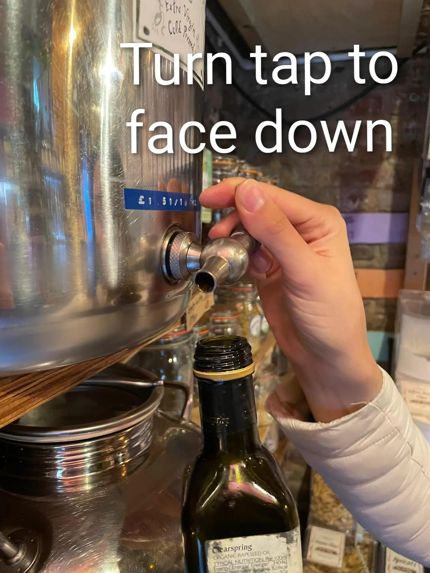 Our oils and vinegar containers are easy to use.
1. Make sure your bottle is weighed and has any plastic insert removed. The bottle does not have to be empty before you arrive. 
2. Turn the tap around so the nozzle points down.
3. Place your bottle