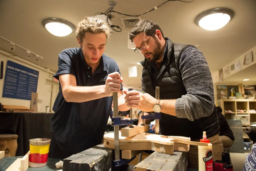 Faculty mentor working with Ross school senior on fabrication of wood guitar body.
