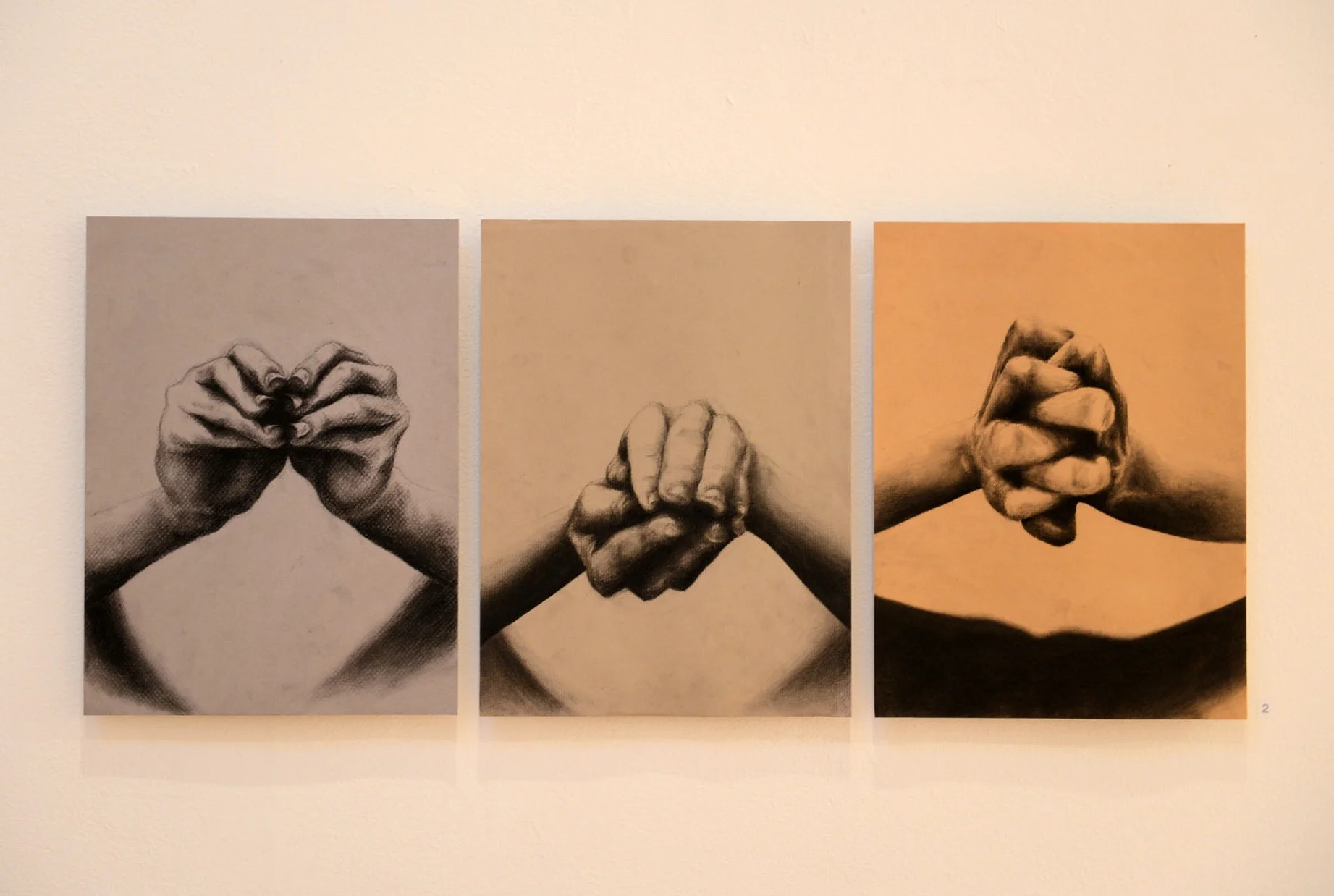 Installation of three large-scale, detailed sketches of clasped hands in different positions