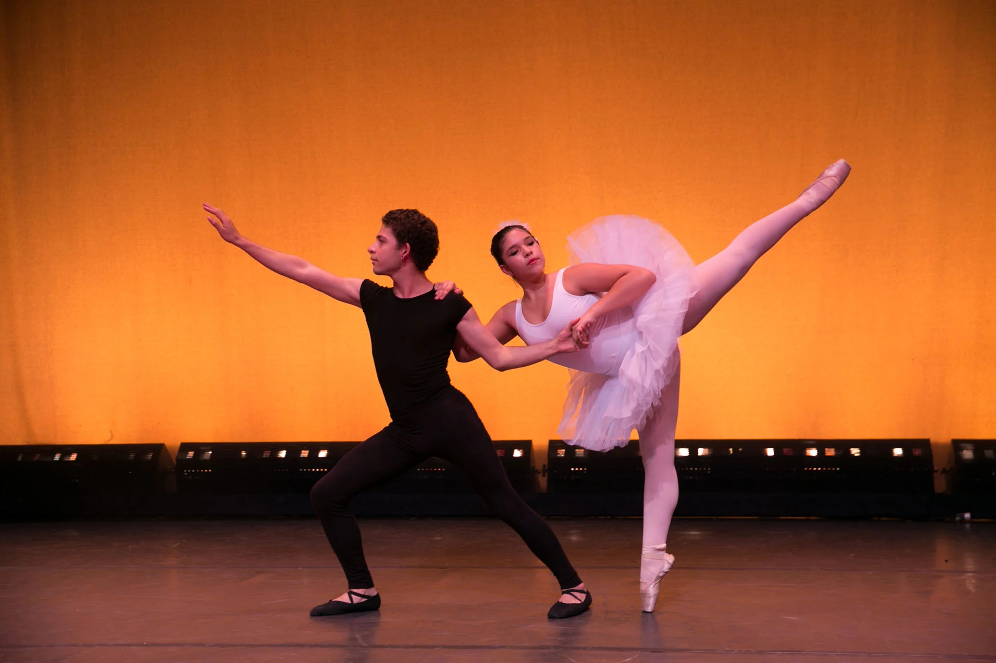 Male and female Ross Upper School students on stage in a ballet performance.
