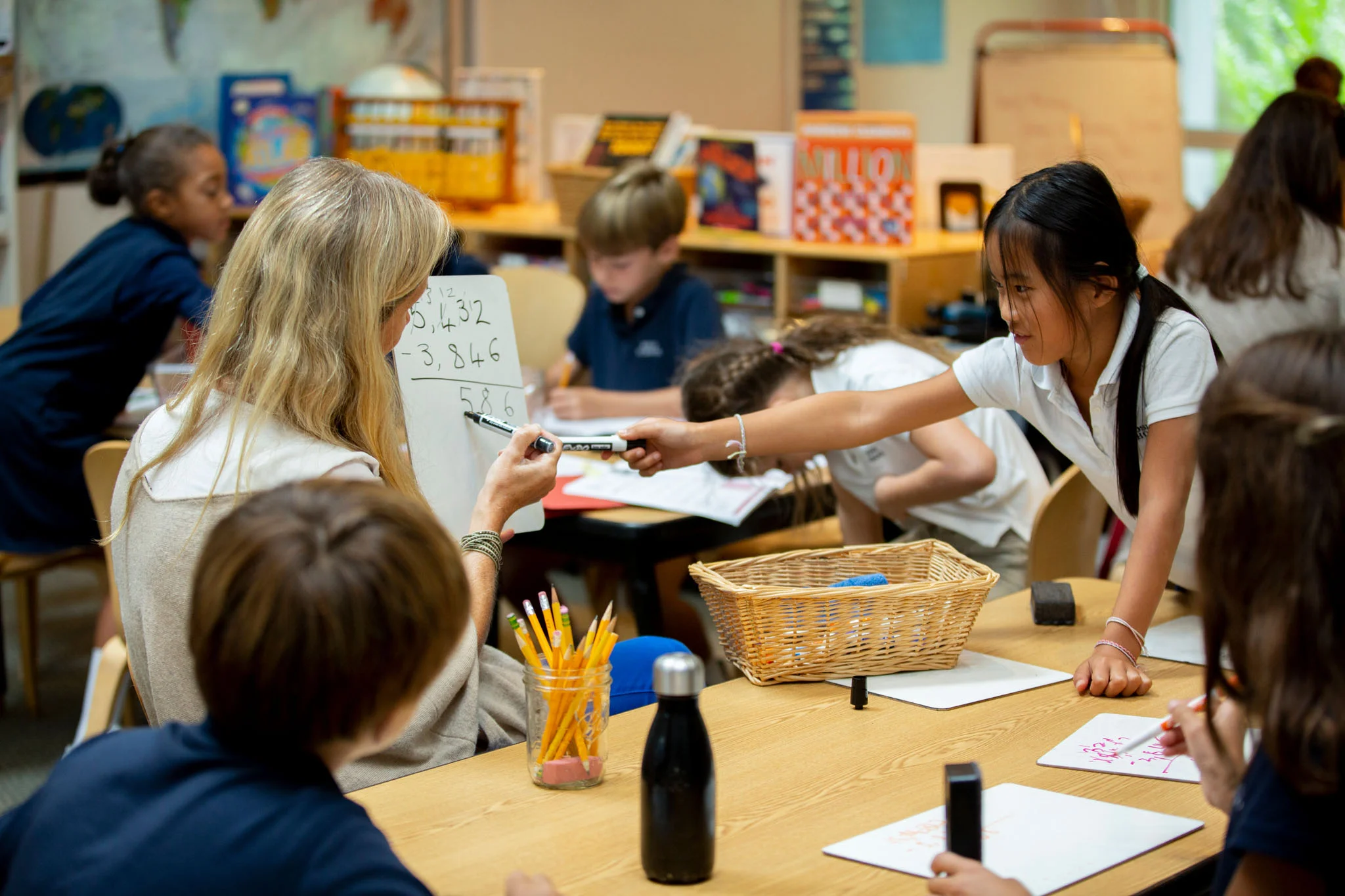 Ross Elementary teacher works with a small group of students on a math lesson.