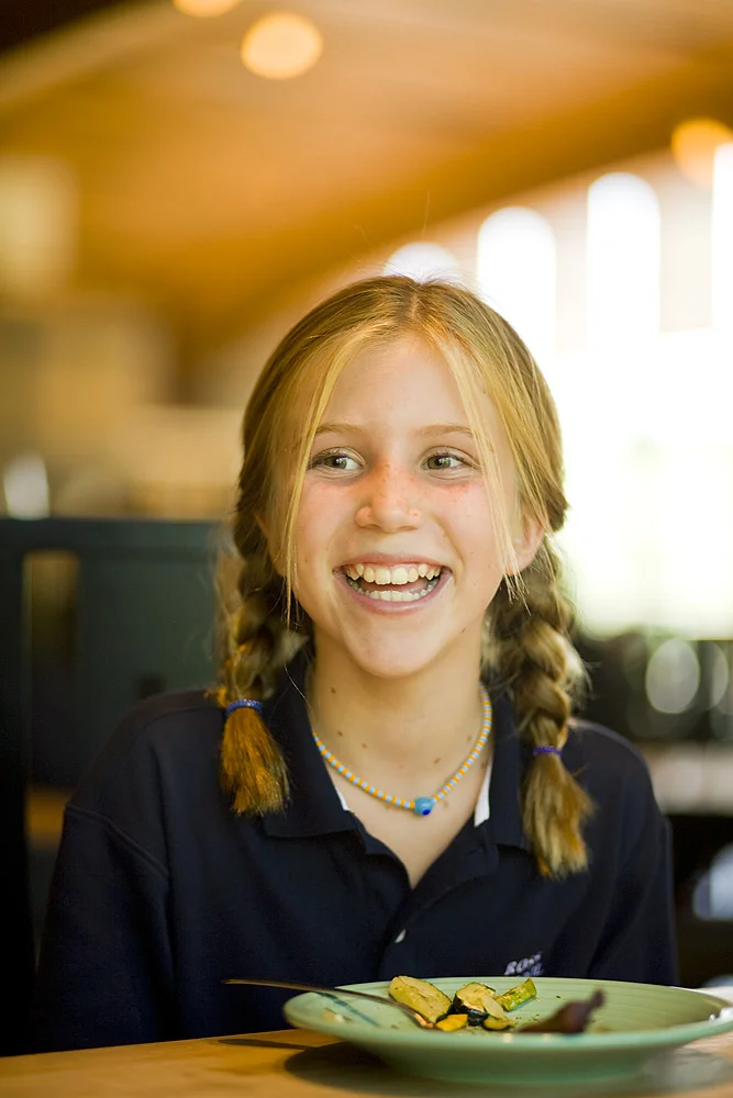 Happy Student Enjoying a Delicious and Nutritious Meal at the Ross School Café’.