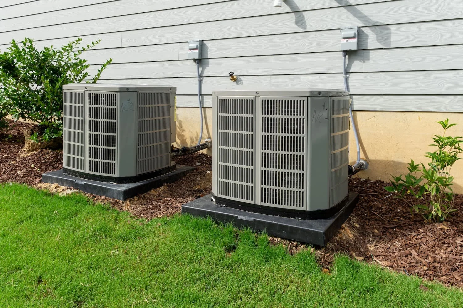 Residential air conditioning units installed outside a home in Concord New Hampshire