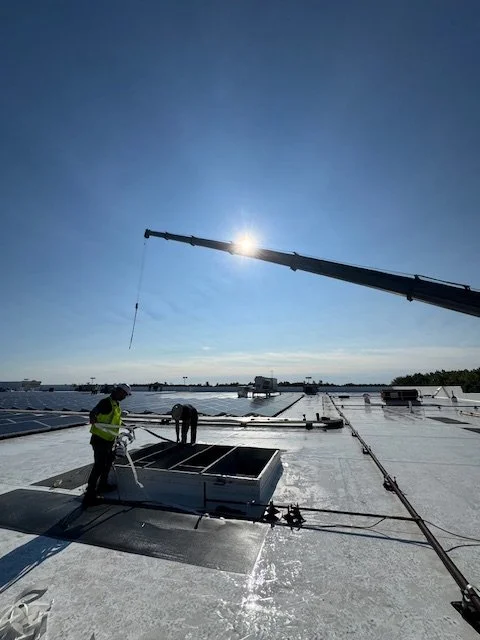 Technicians installing rooftop HVAC system in Concord New Hampshire