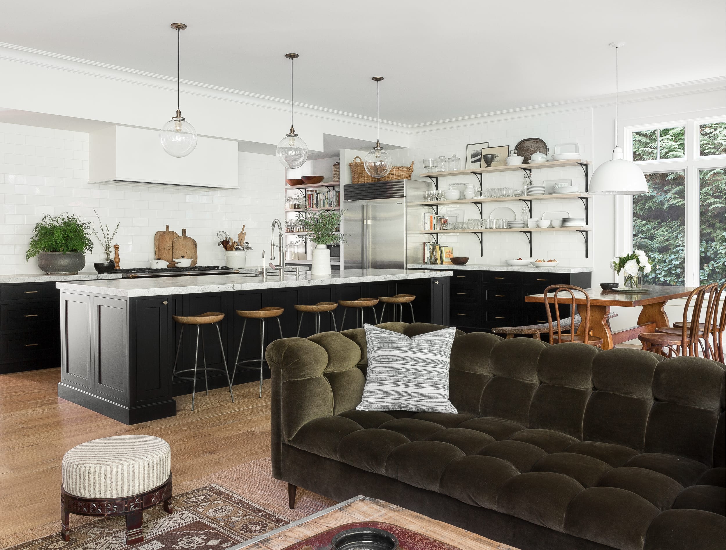 long breakfast bar and designer lighting in open format kitchen and living room