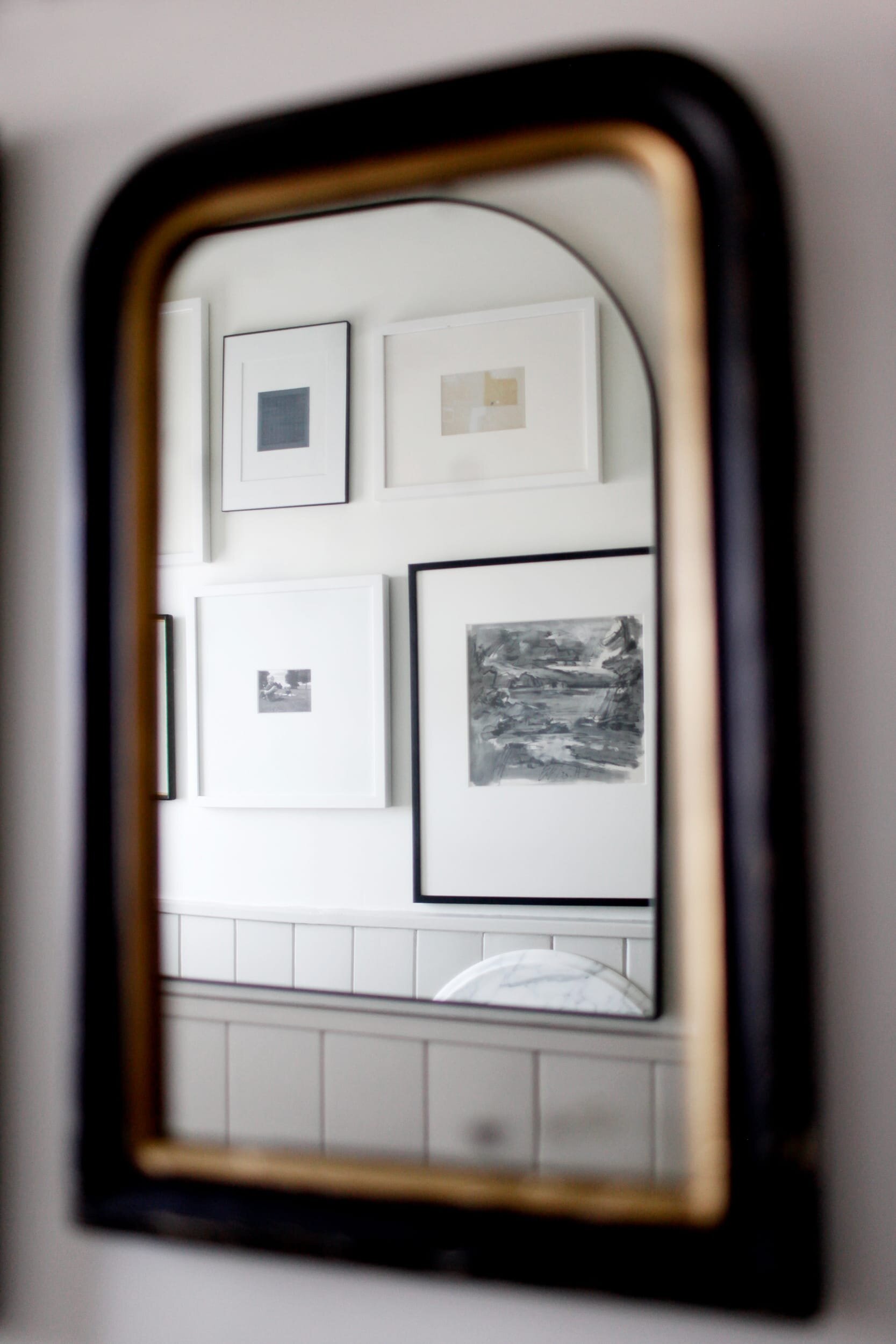 Rounded square mirror in powder room