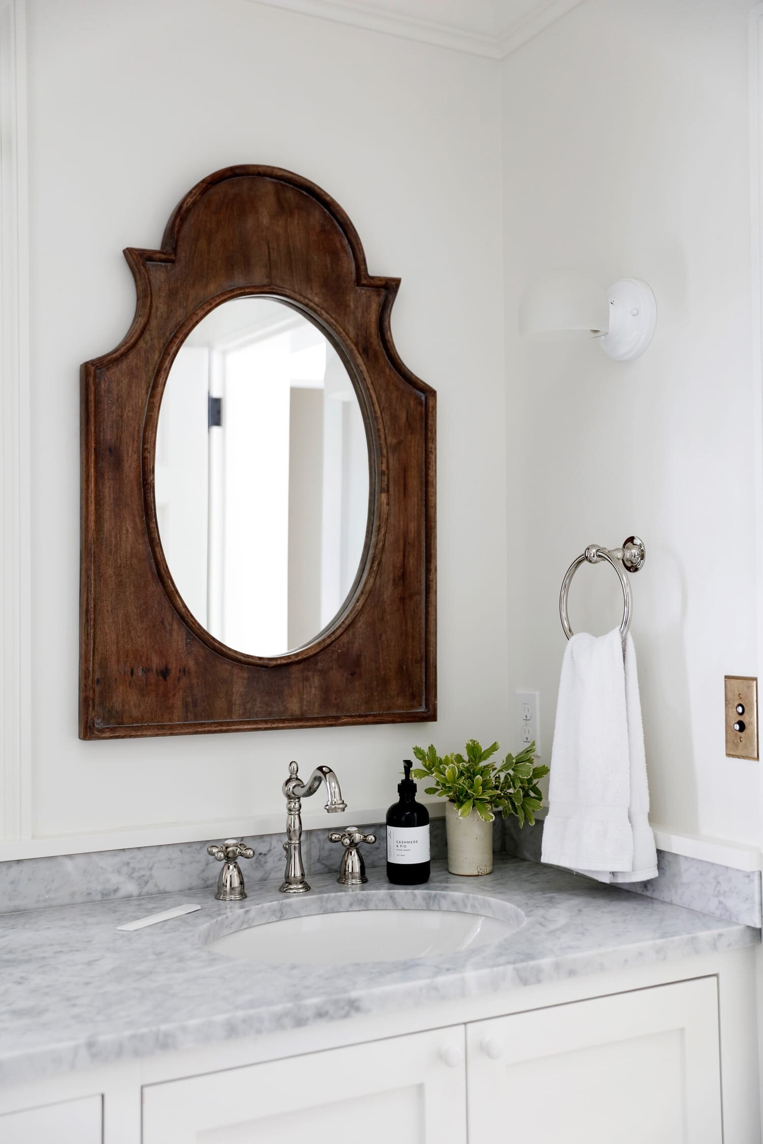 Antique mirror above marble bathroom sink