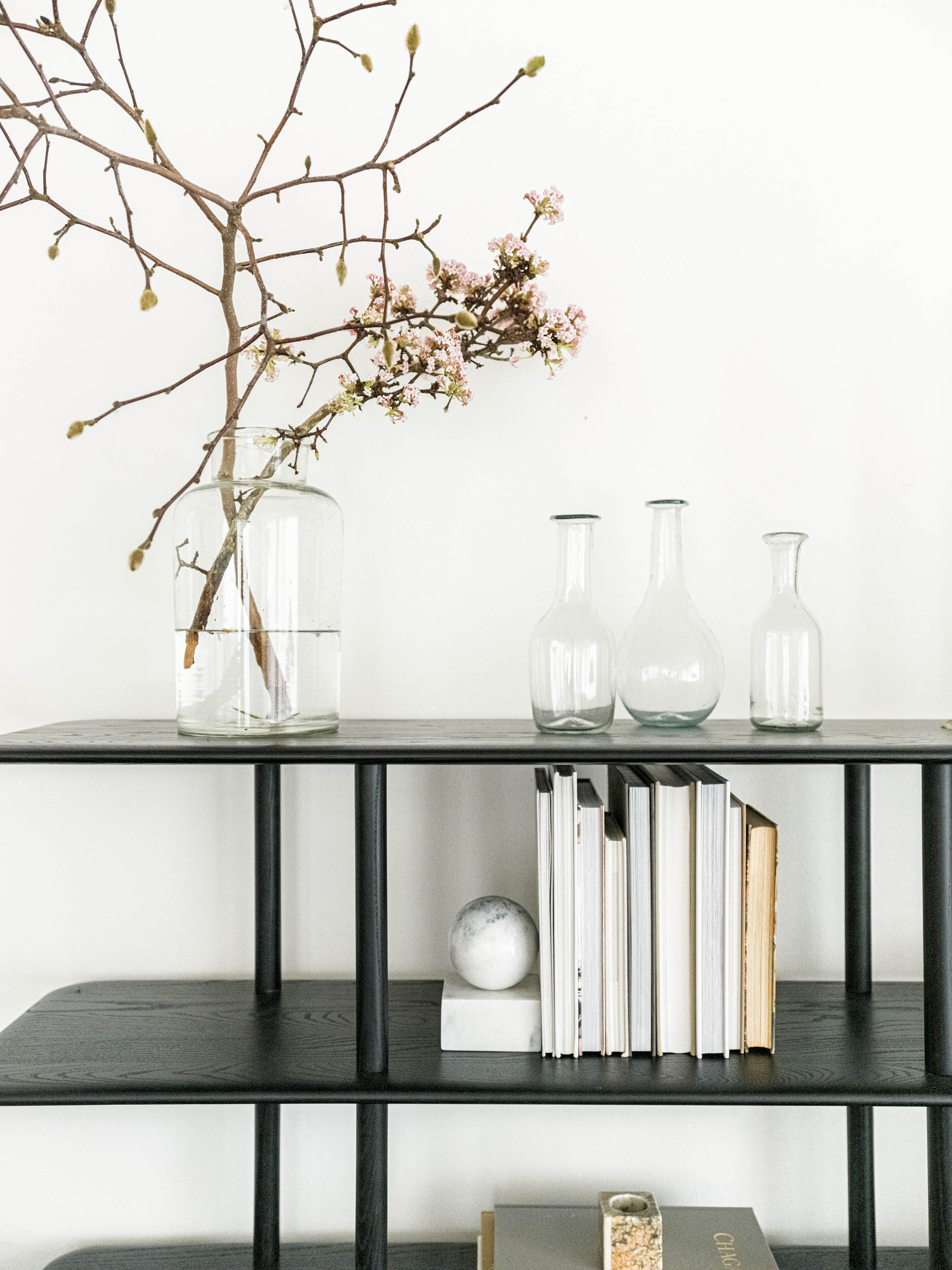 ebonized open shelves with earthy accessories