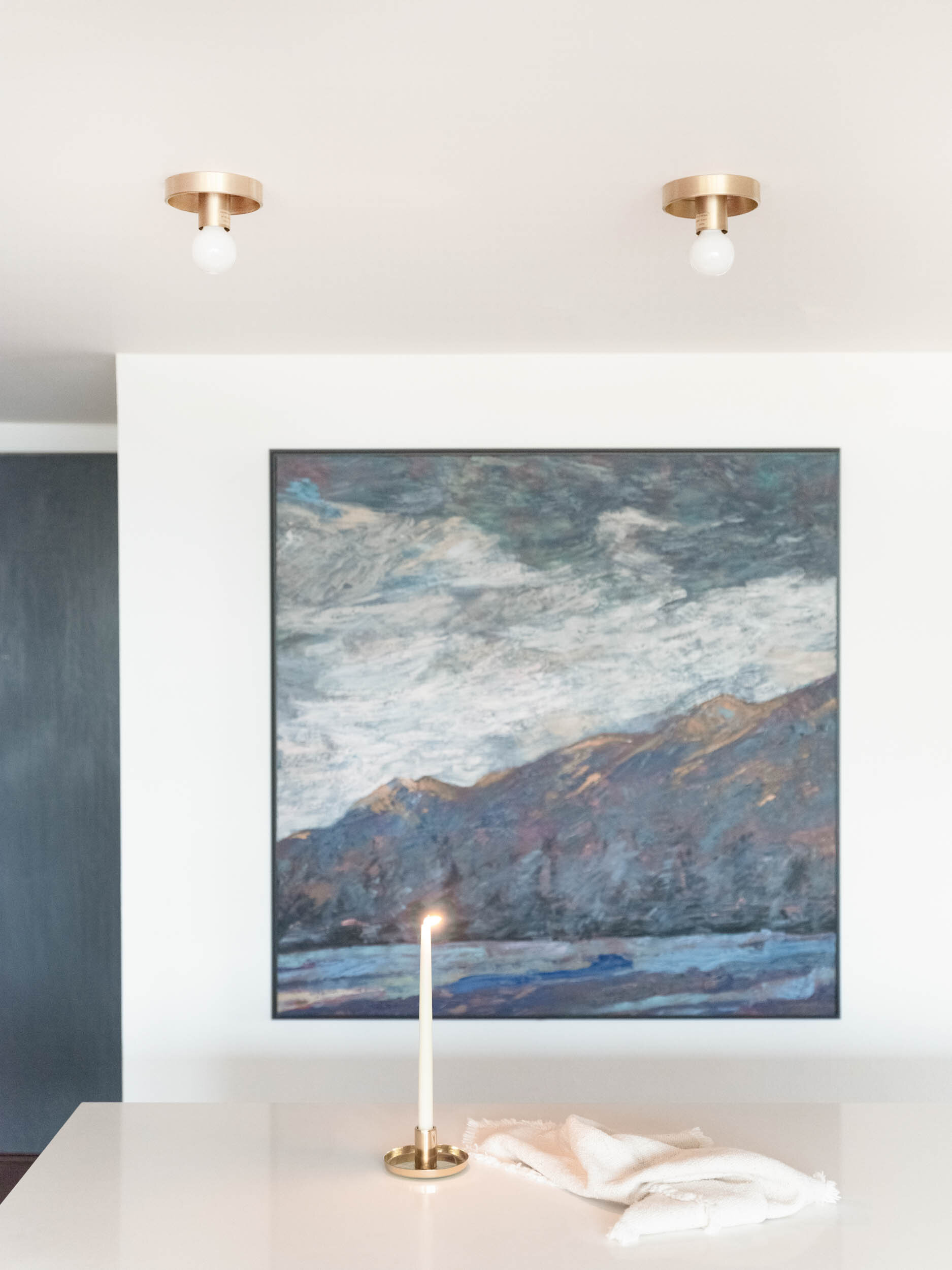 moody colored painting in dining room