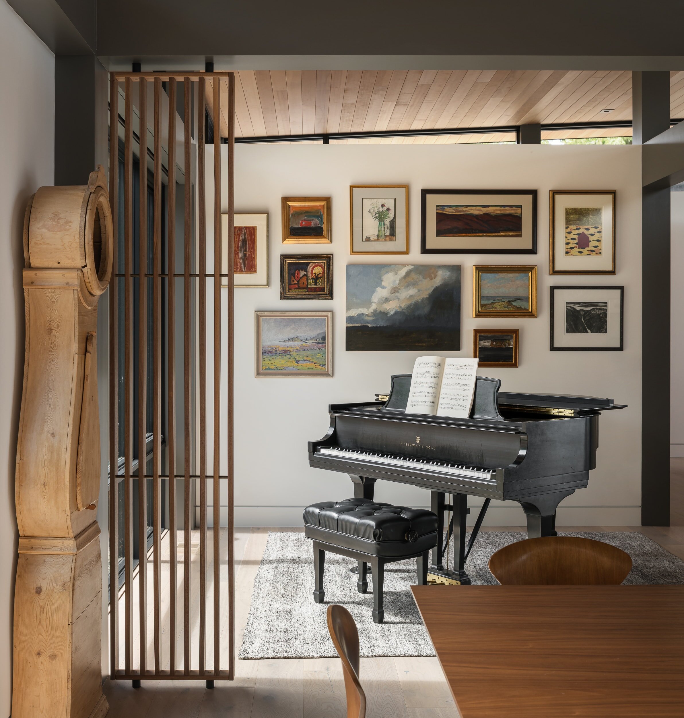 remodeled music room with grand piano as centerpiece surrounded by art